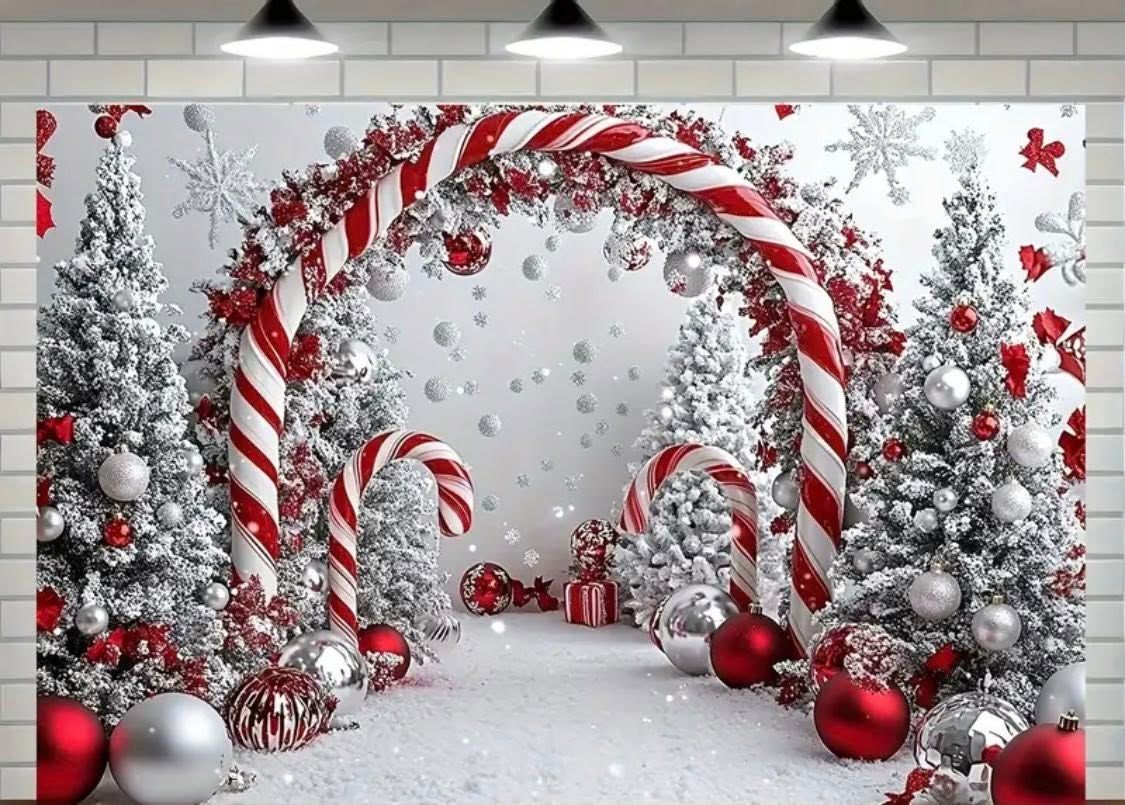 Red and white candy cane decorations with silver ornaments and frosted pine branches create a festive holiday display.