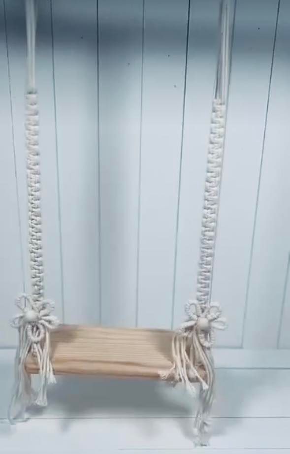 Wooden swing seats with rope knots hang in a row