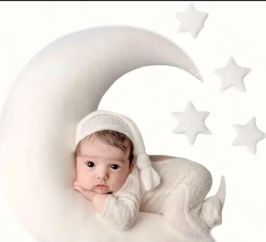 A dreamy backdrop with stars and crescent moon decorations.