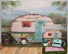 A series of vintage camper trailers decorated with colorful bunting and retro decor parked in a scenic outdoor setting.