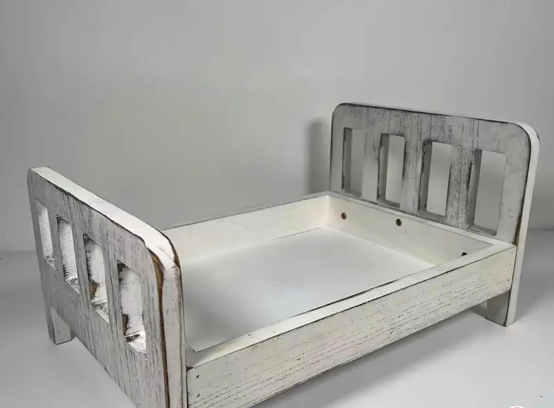 A  modern white wooden bed frame for baby