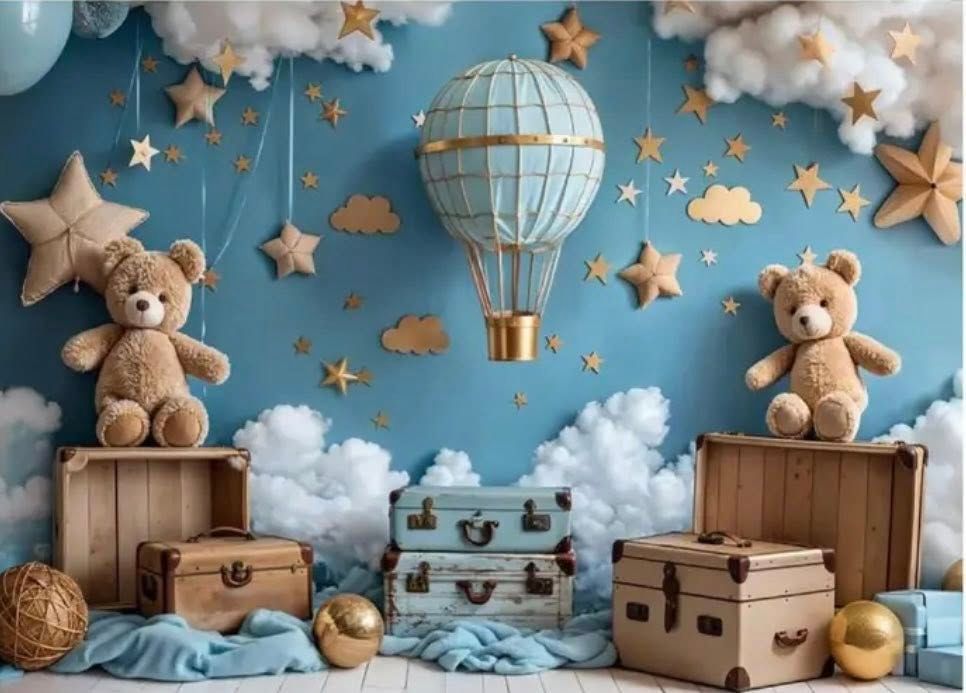 Whimsical nursery decor with teddy bears, wooden boxes, hanging stars, hot air balloons and cotton cloud decorations.