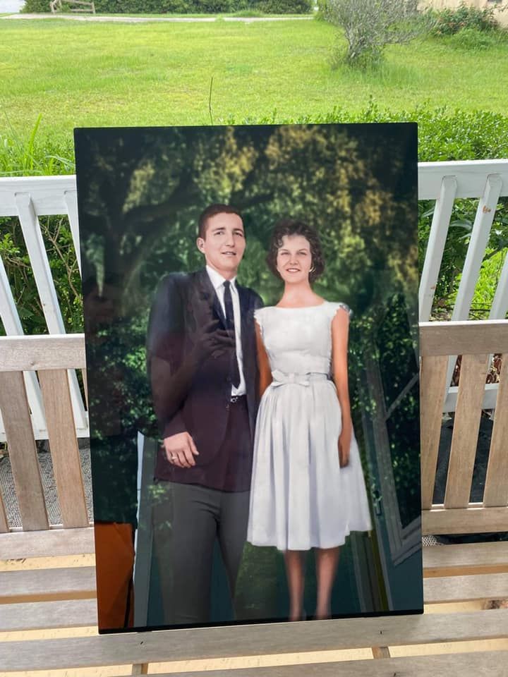 Vintage photograph from the 1950s showing a couple in formal attire posing outdoors. Photo Restoration