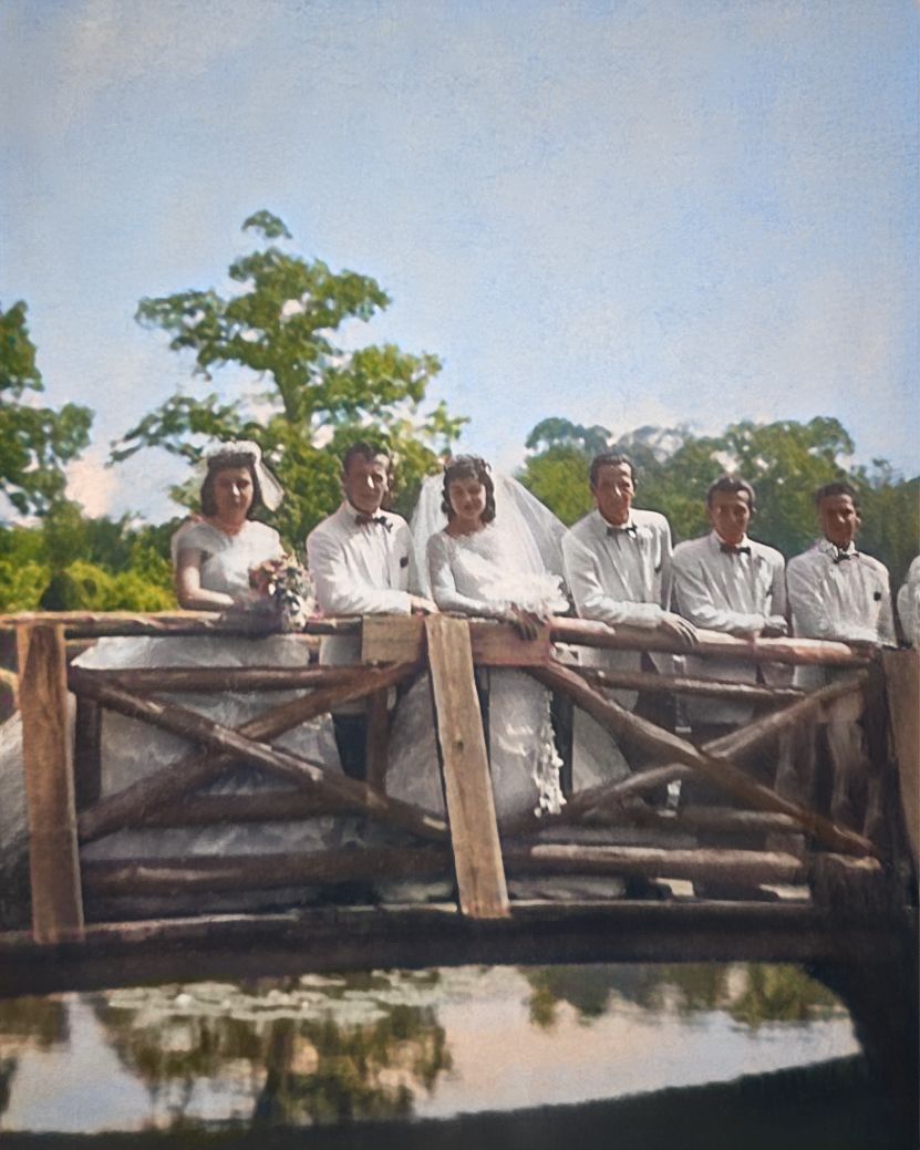 Historical black and white photograph of people gathered on wooden bridge over water. Restored by Rhode Island digital photo restorer