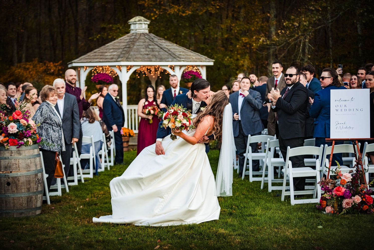 Outdoor wedding ceremony setup with white folding chairs and a gazebo in autumn. Bittersweet Farm Rhode island wedding.