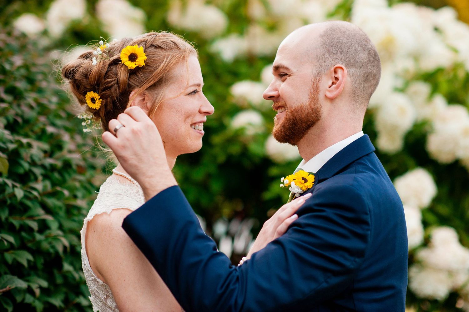 Romantic outdoor wedding portraits with sunflowers against a natural garden backdrop. Taken by Rhode island wedding photographer