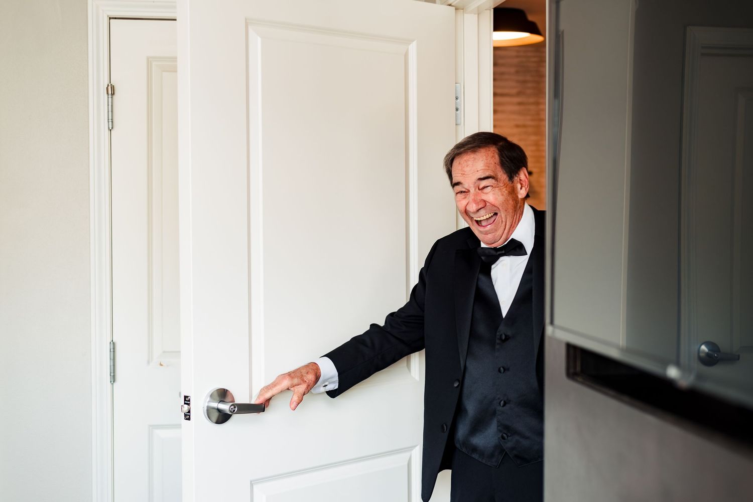 Getting ready moments captured in a bright interior space with white walls. Taken by Rhode Island wedding Photographer
