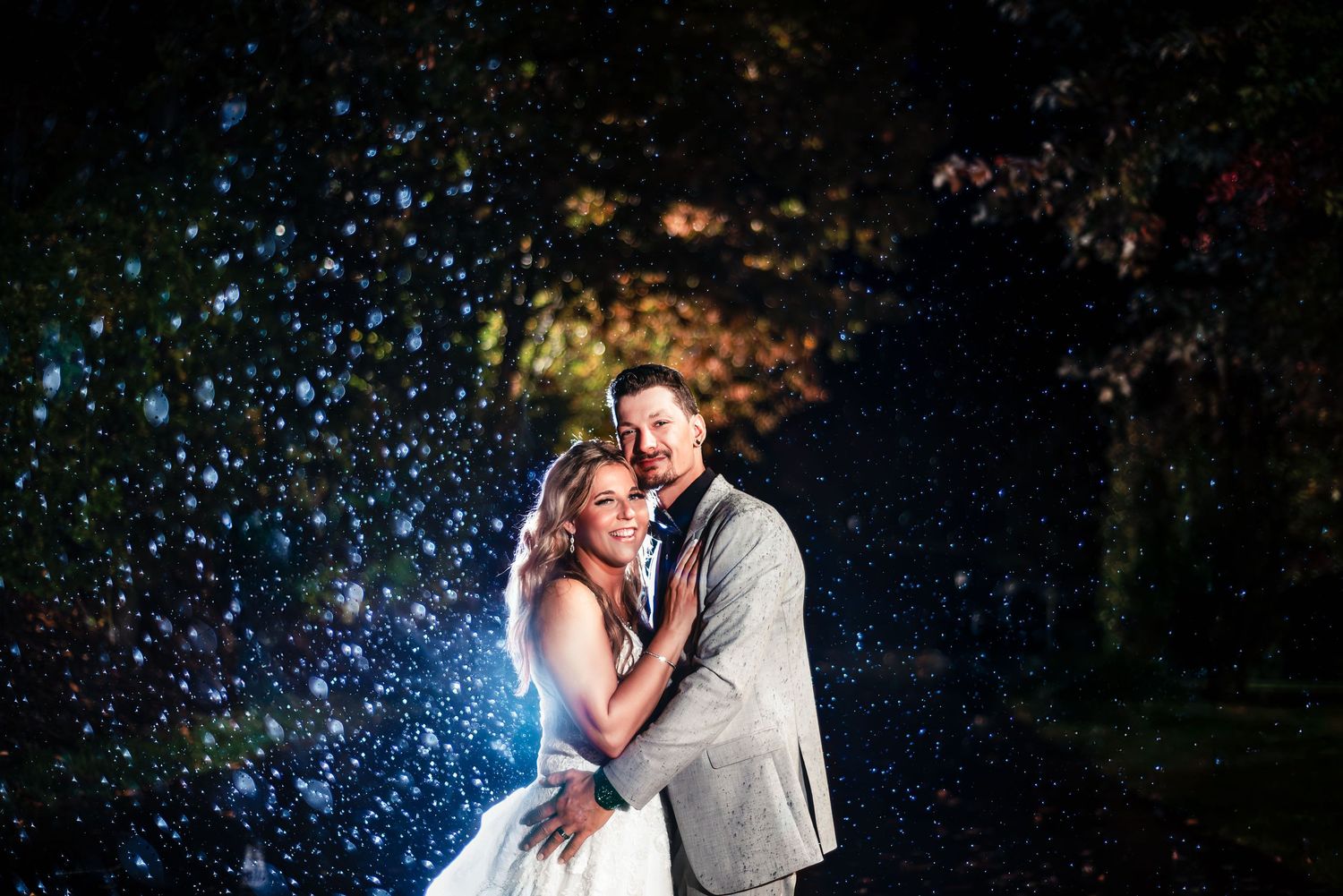 Romantic nighttime portrait with sparkling bokeh lights in the background. Taken by Rhode island wedding photographer