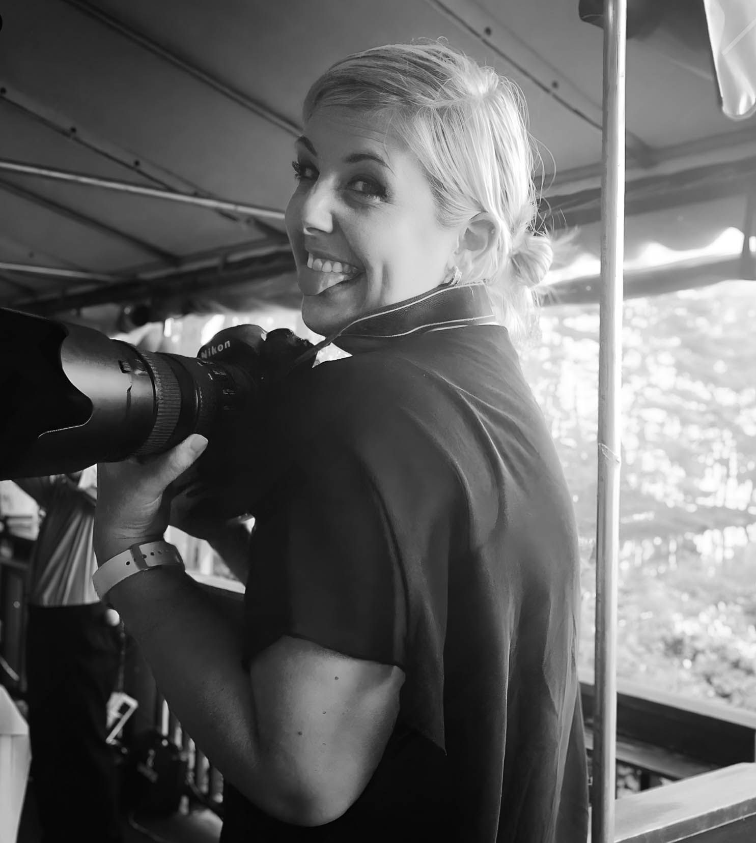 Rhode Island Photographer wearing black shirt taking pictures in outdoor setting.