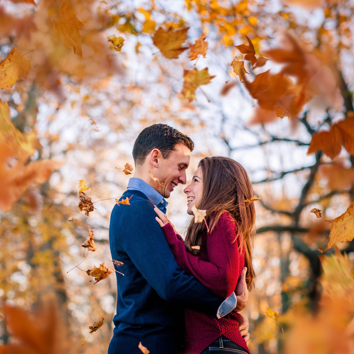Autumn engagement photos with vibrant orange fall foliage in the background. Taken by Rhode Island Photographer
