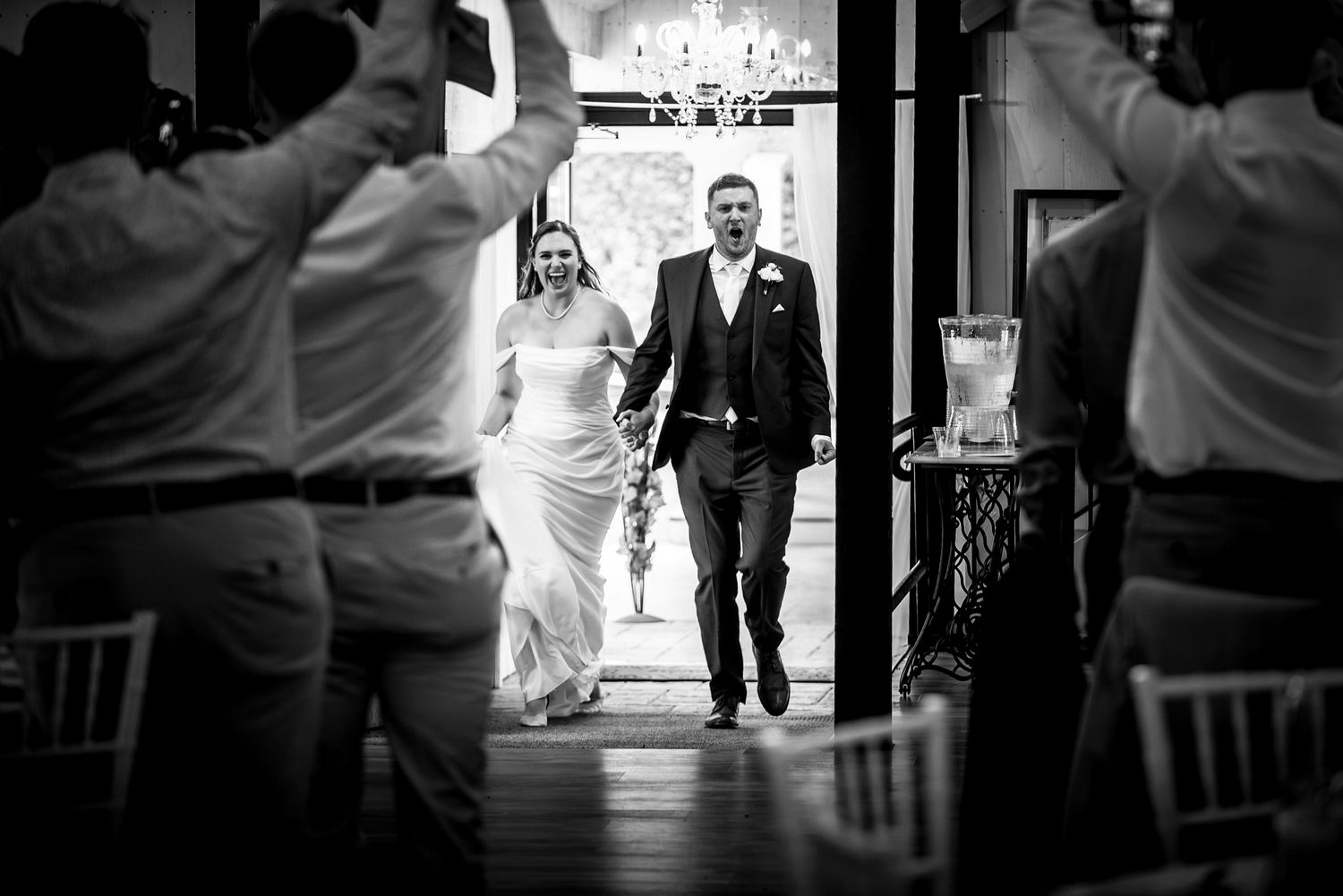 Black and white wedding photos showing silhouettes of guests in an elegant venue. Taken by Rhode island wedding photographer