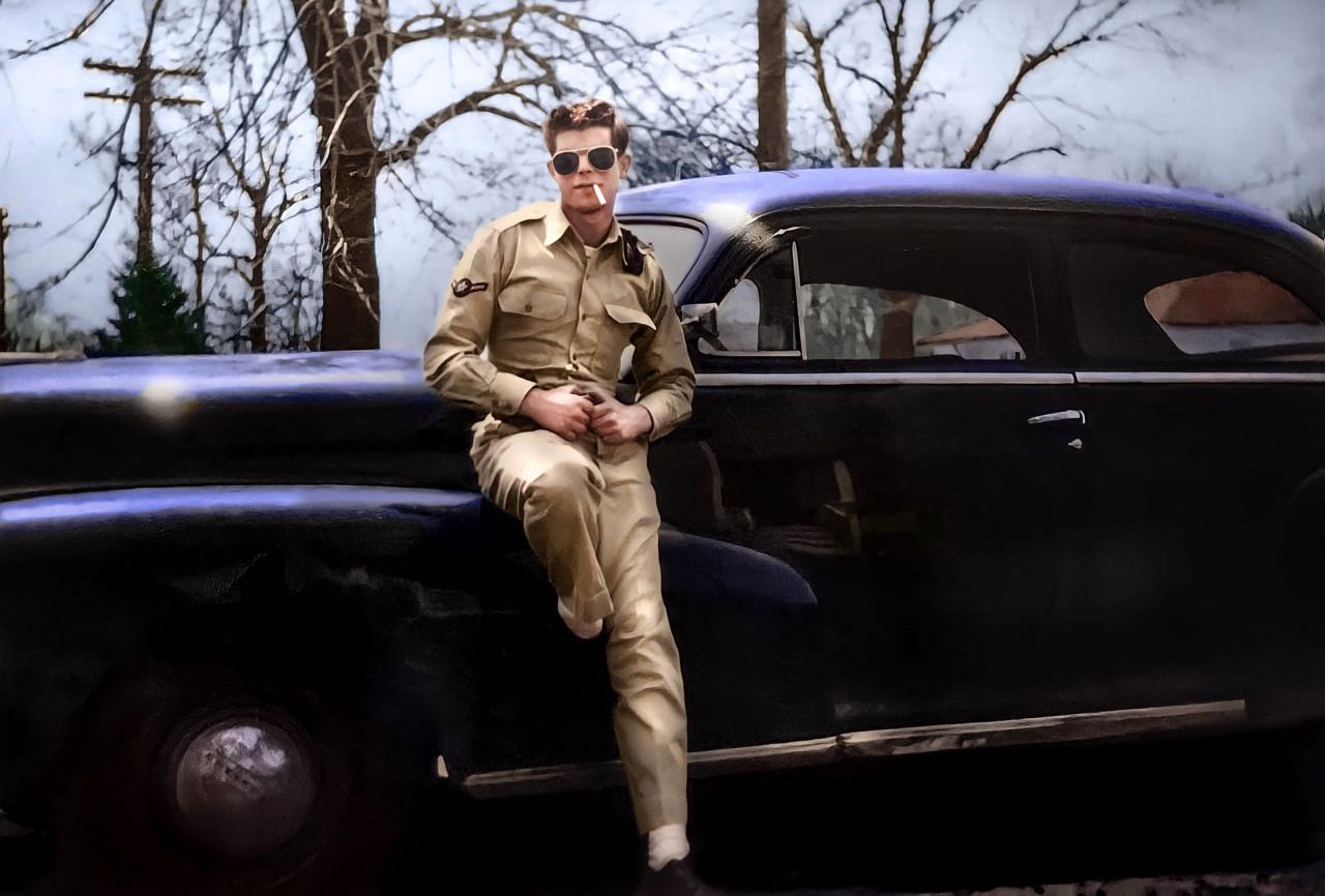Classic car parked under bare winter trees in moody lighting. photo restoration