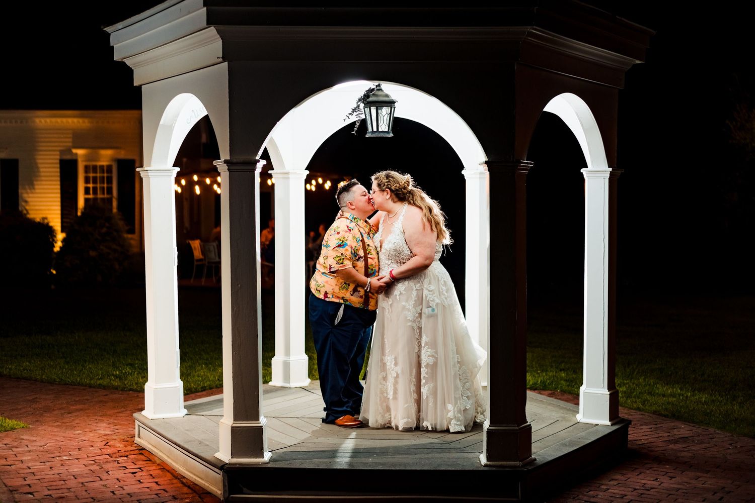 Wedding couple poses in an elegant white gazebo at night. Five Bridge Inn Wedding, Taken by Rhode Island wedding Photographer