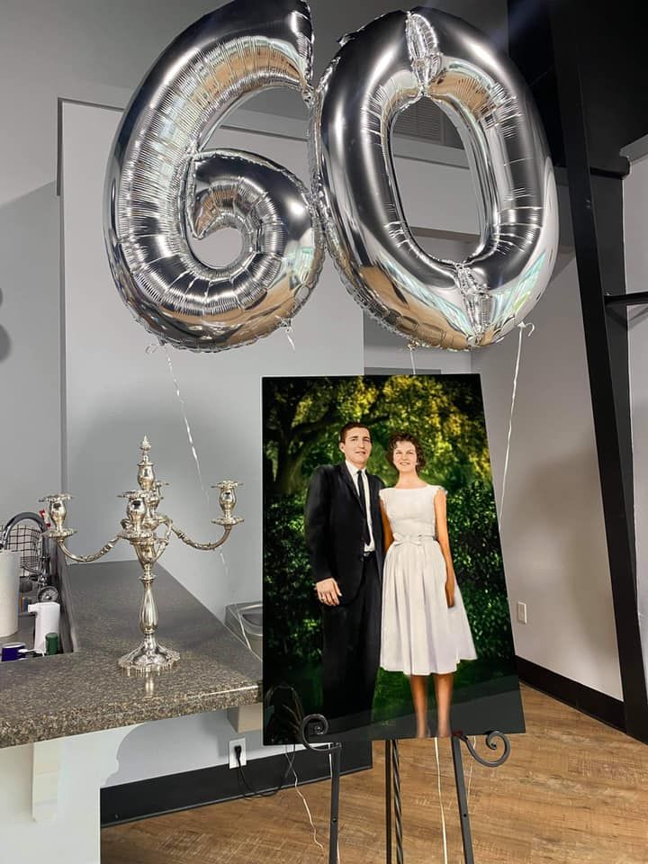 60th anniversary celebration setup with silver balloons and decorative elements. Photo Restoration