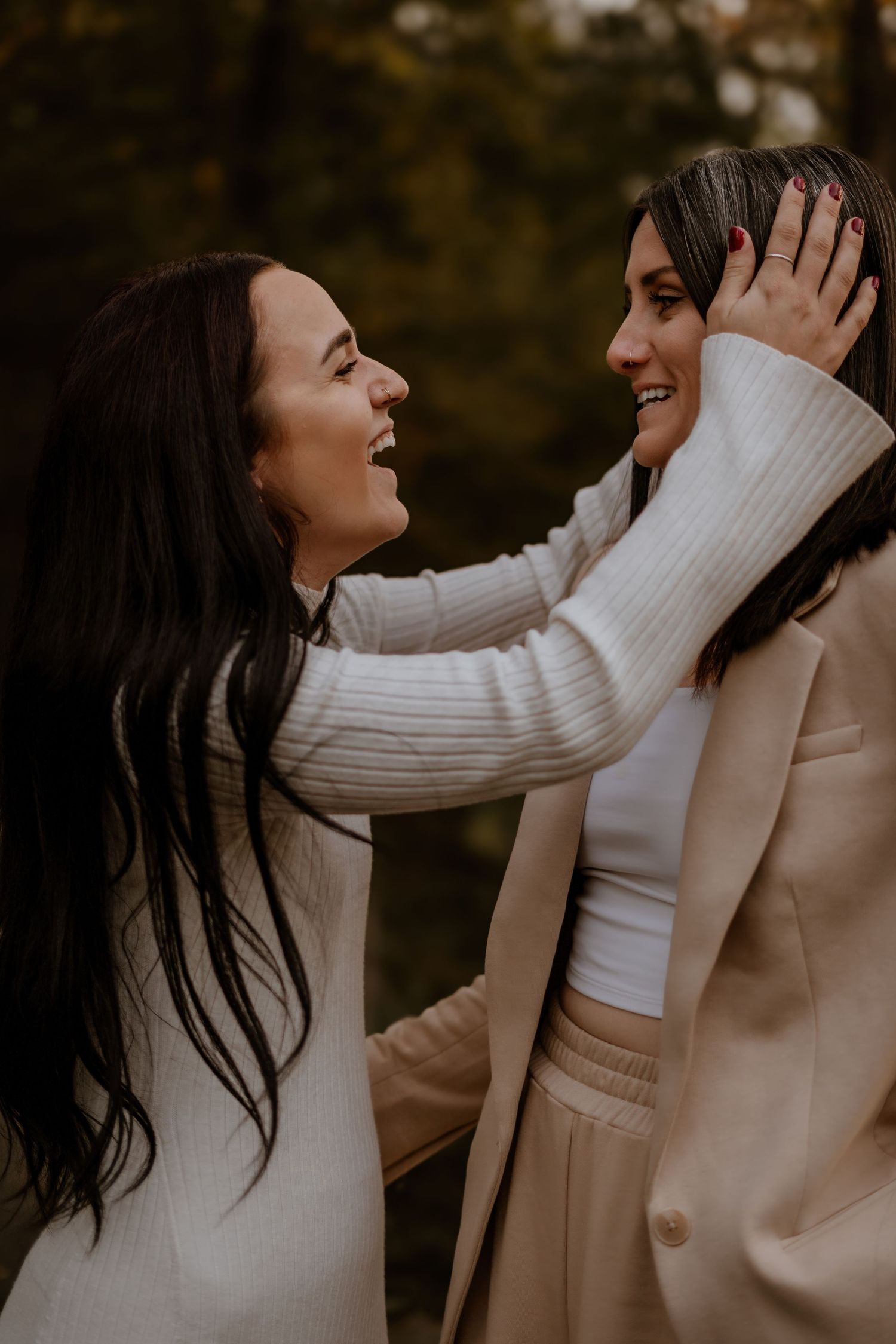 Candid moments of joy and laughter between a couple wearing neutral sweaters.