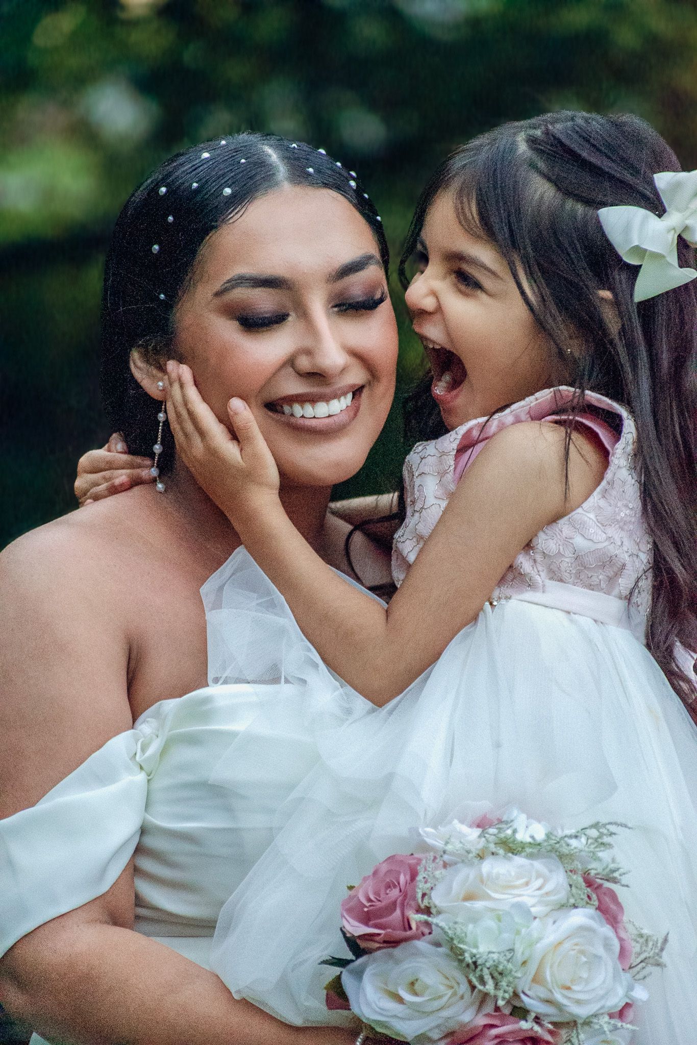 Tender moment shared with white floral bouquet in frame.