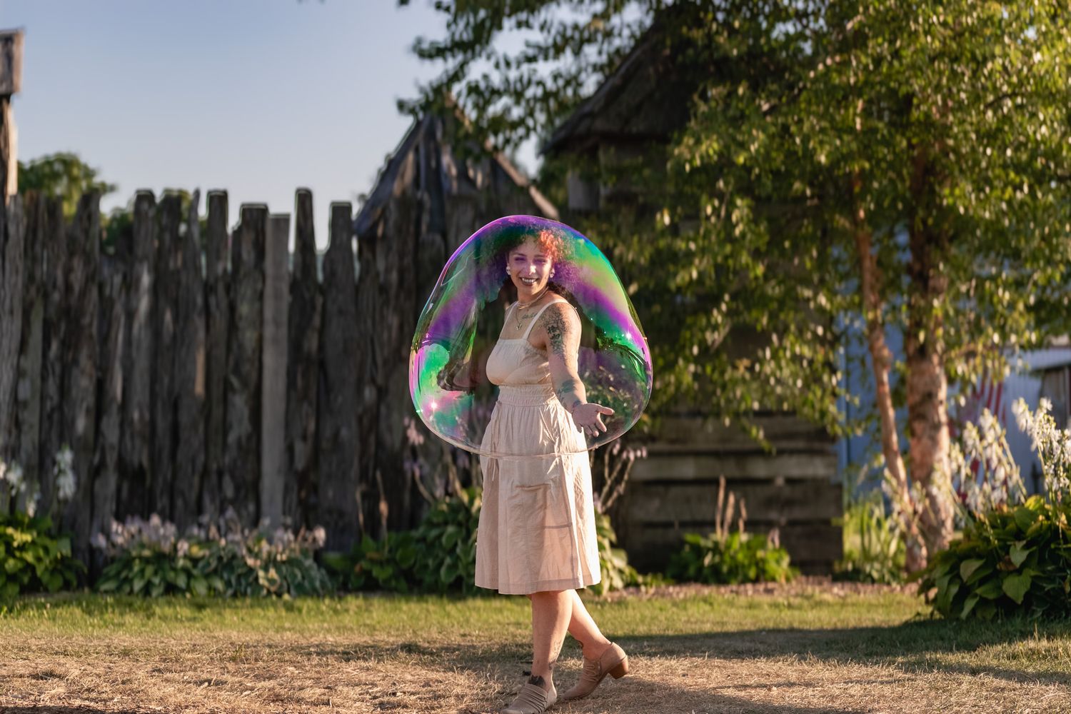 Colorful soap bubbles floating in sunlit garden setting.