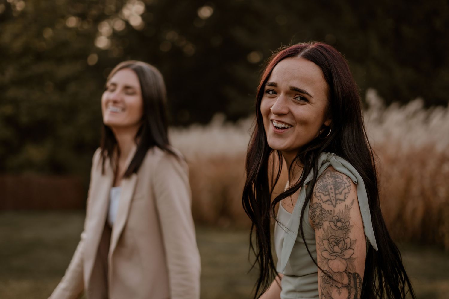 Candid laughter and joy captured during an outdoor engagement photo session.
