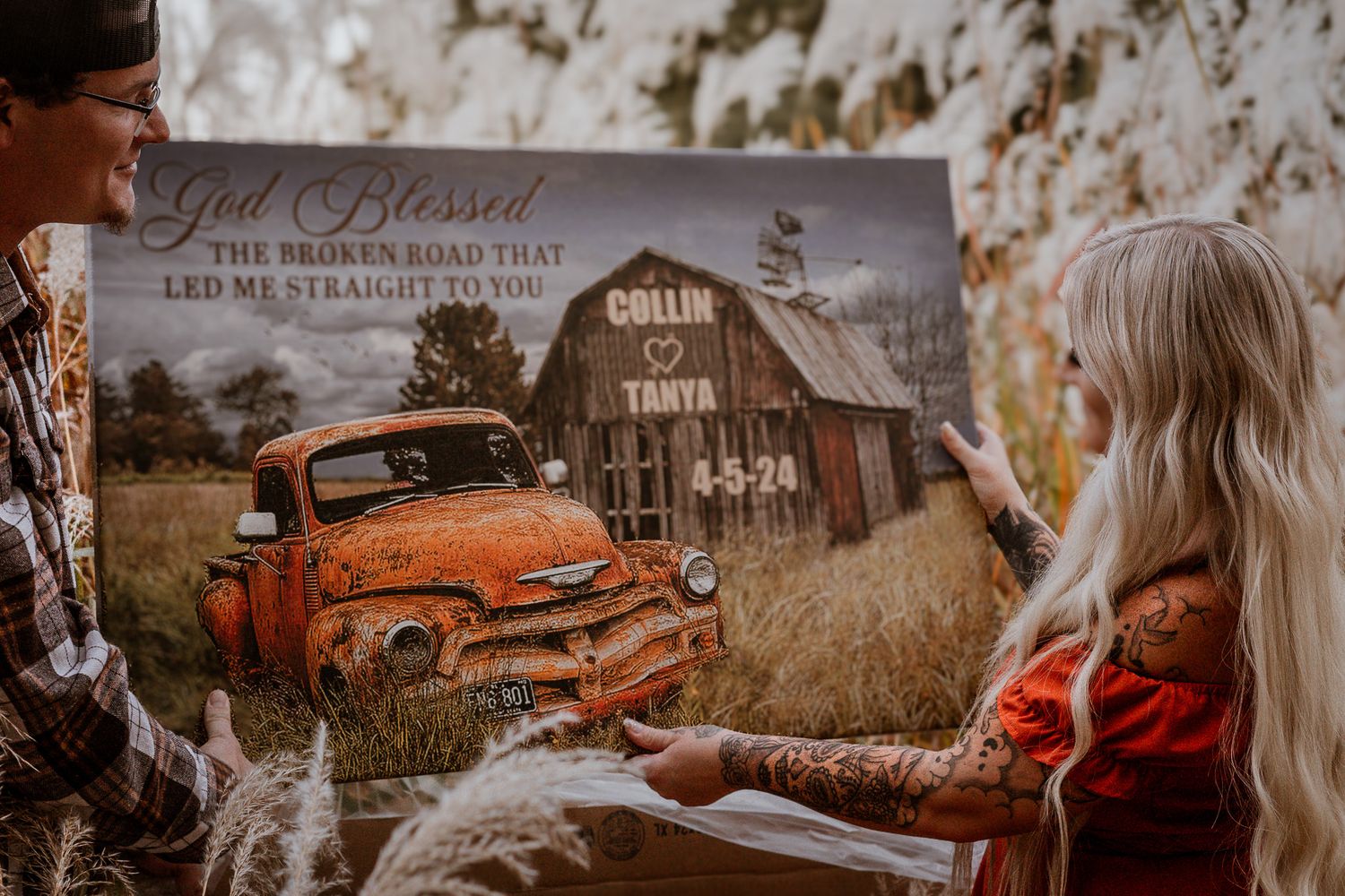 A vintage orange truck sits in front of a rustic barn in a rural countryside setting at sunset.