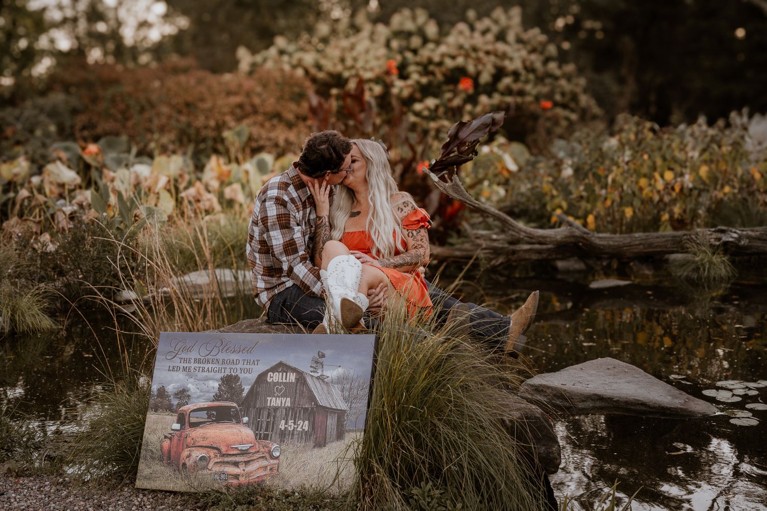 A couple shares a romantic moment on a log surrounded by autumn foliage.