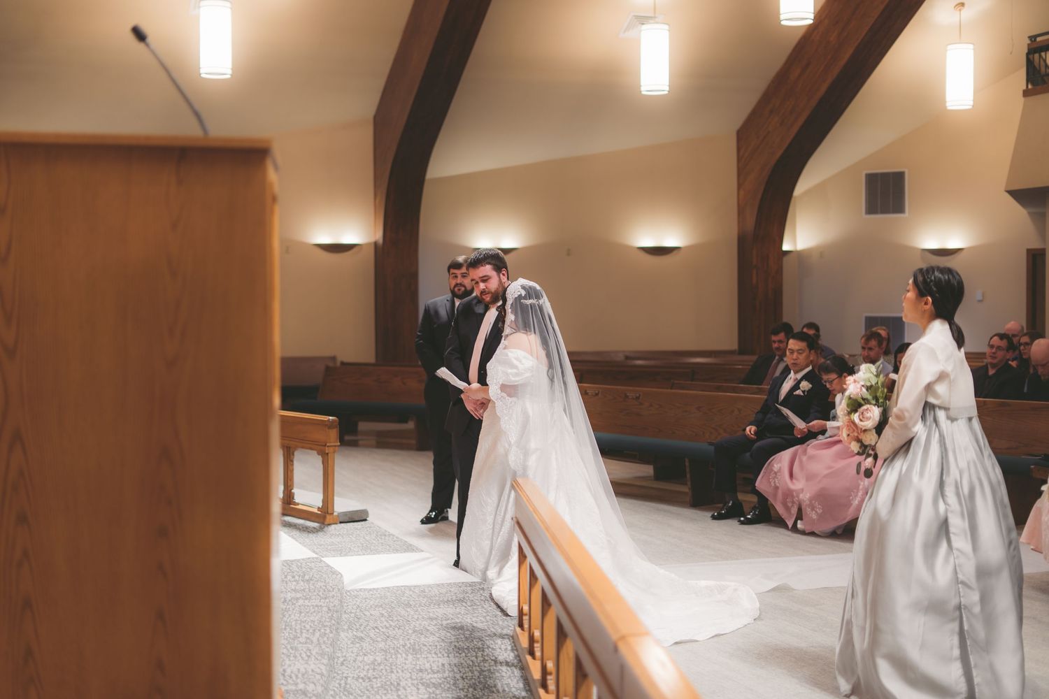 Bride and groom exchange vows at church altar during intimate wedding ceremony.