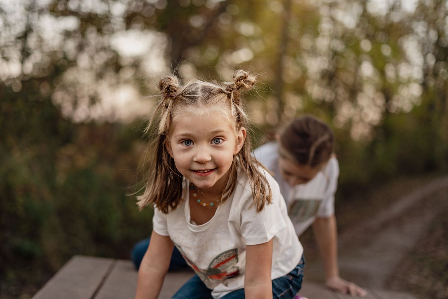 Young person playing in nature during an autumn photo session.
