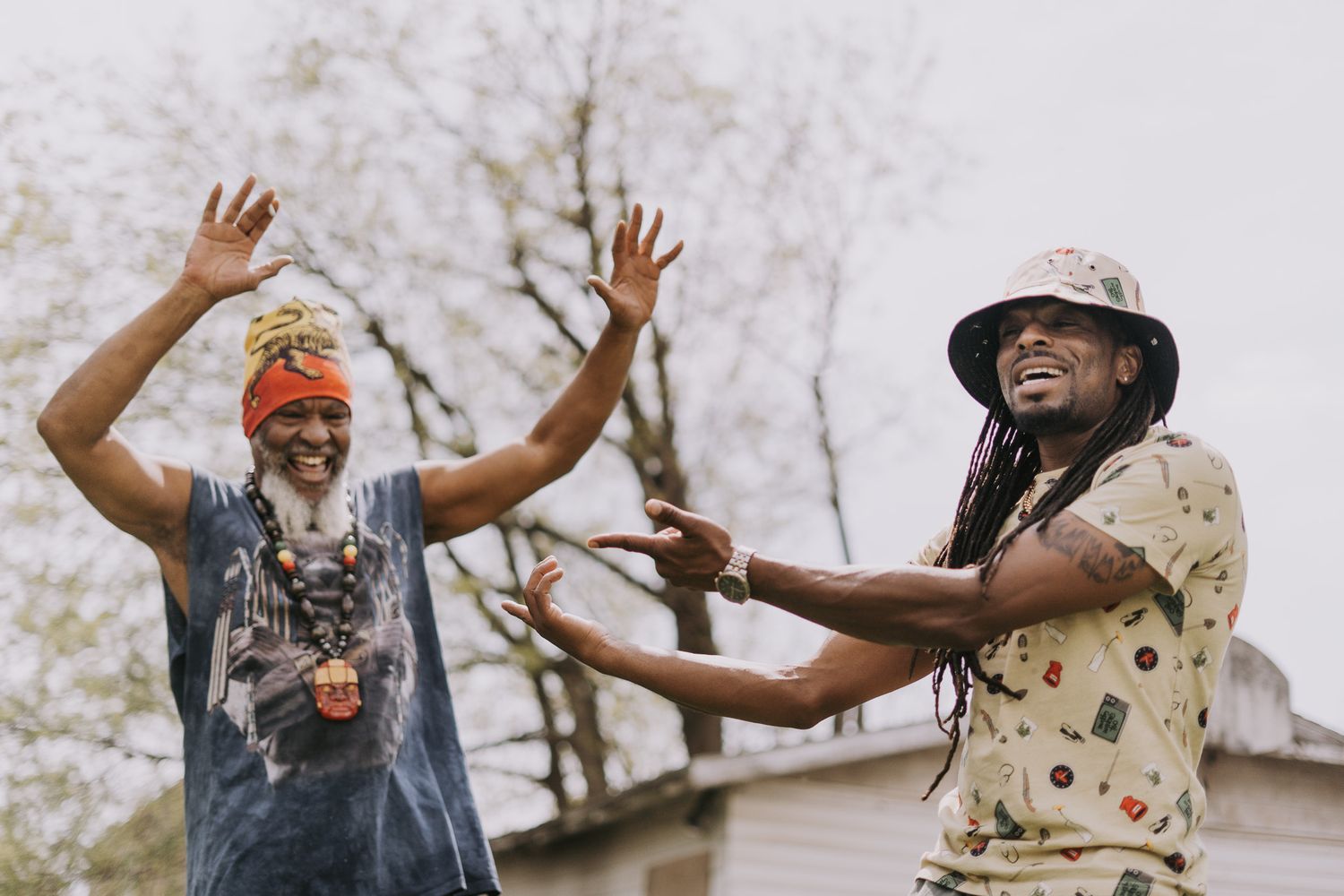 Group of friends dancing and celebrating outdoors with energetic poses.