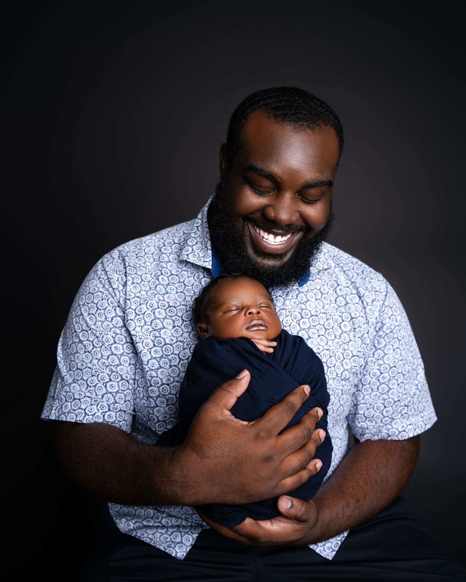 Metro Detroit newborn photographer capturing a peaceful newborn with father portrait in studio