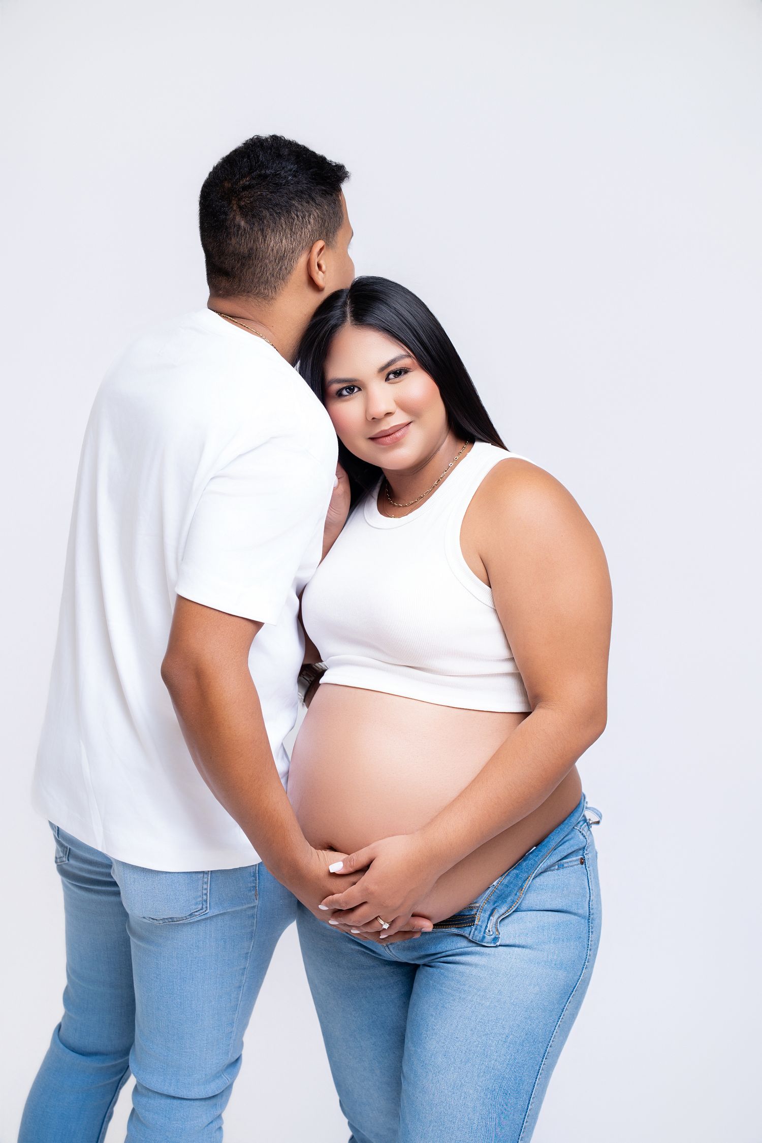 Metro Detroit maternity photographer capturing an expecting couple in studio.
