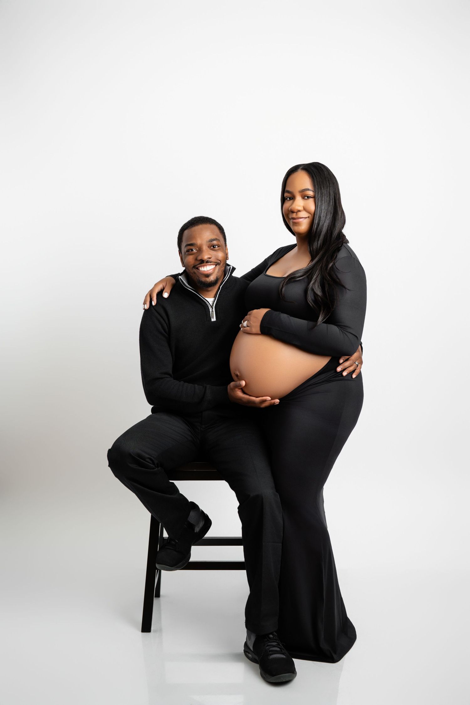 Metro Detroit maternity photographer capturing an expecting mother and husband in studio