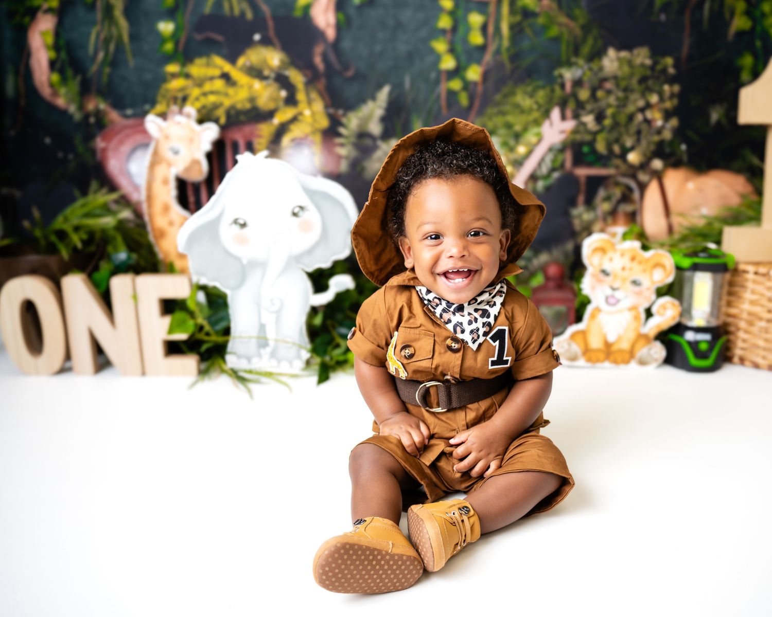 Metro Detroit children photographer photographing a playful toddler in studio Safari-themed first birthday photoshoot