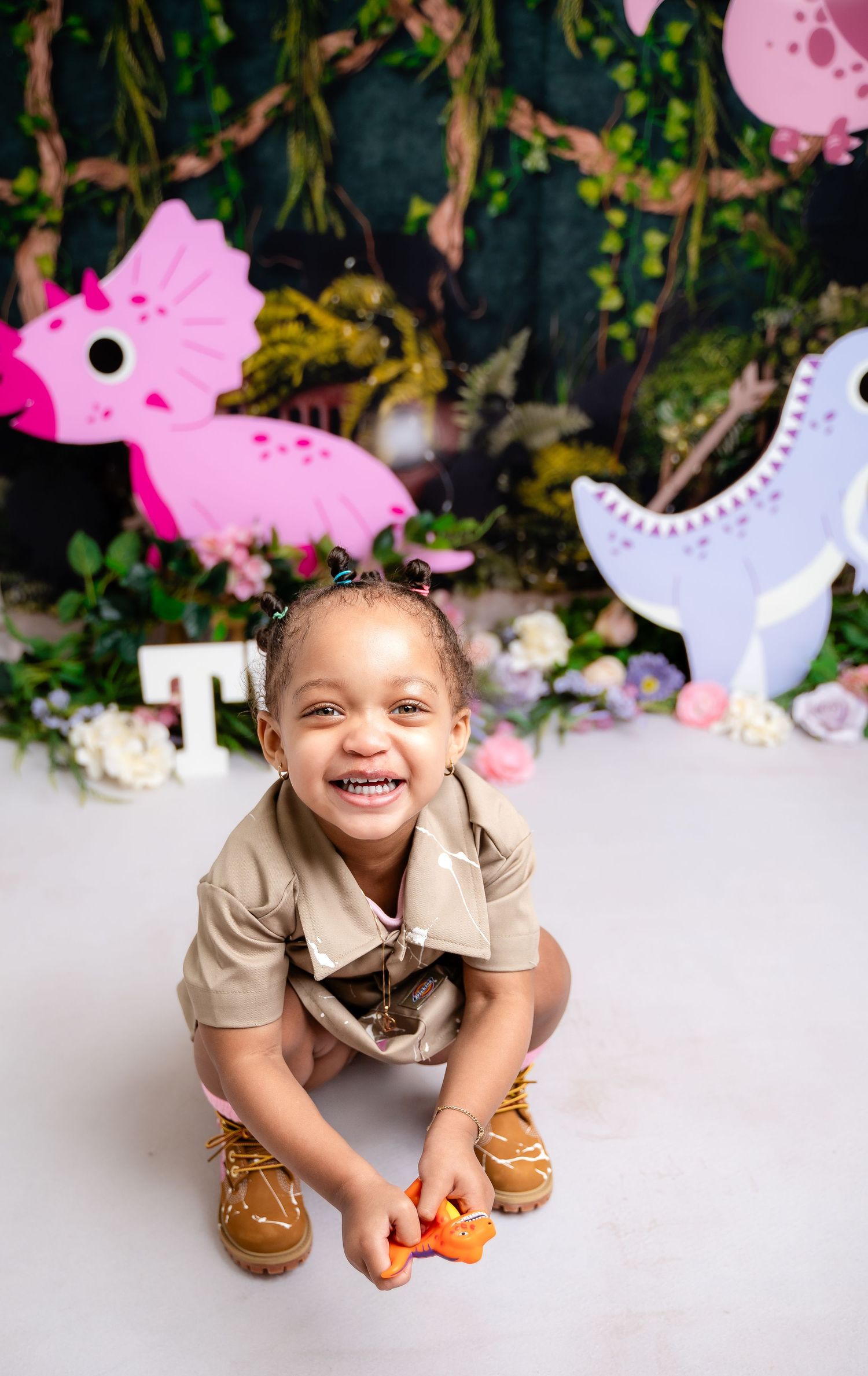 Metro Detroit children photographer photographing a toddler in studio for Whimsical dinosaur themed photo session