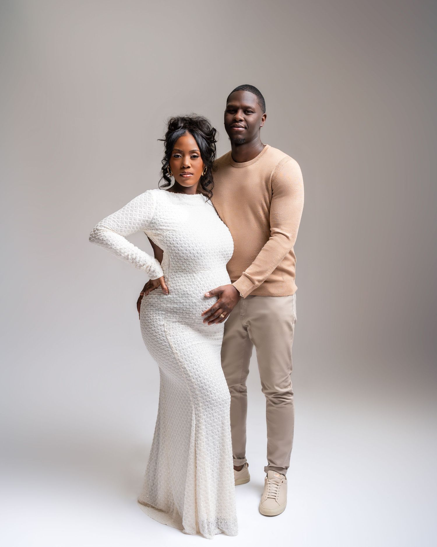 Metro Detroit maternity photographer capturing an expecting couple in studio