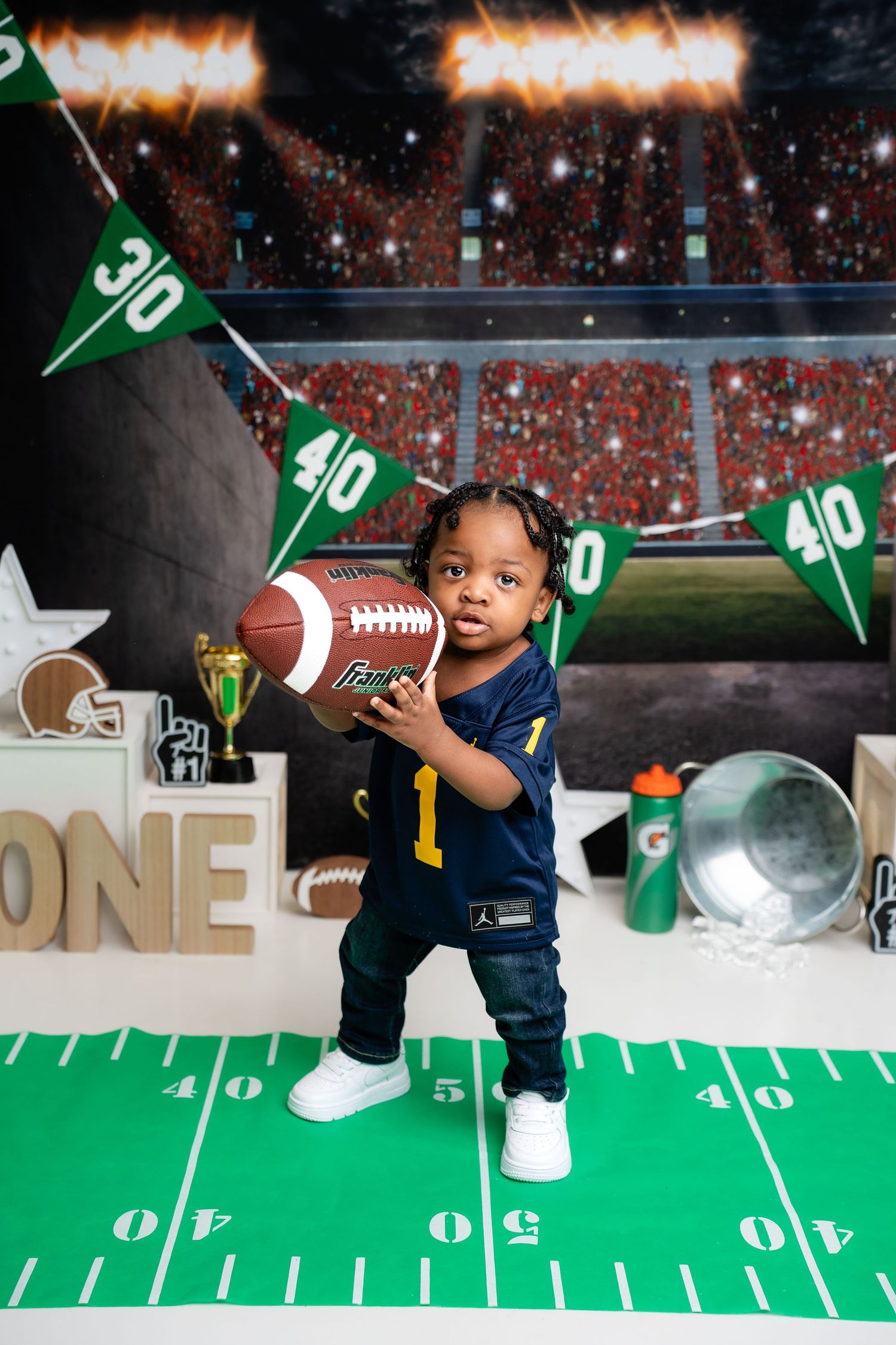 Metro Detroit children photographer photographing a playful toddler in studio Football themed first birthday