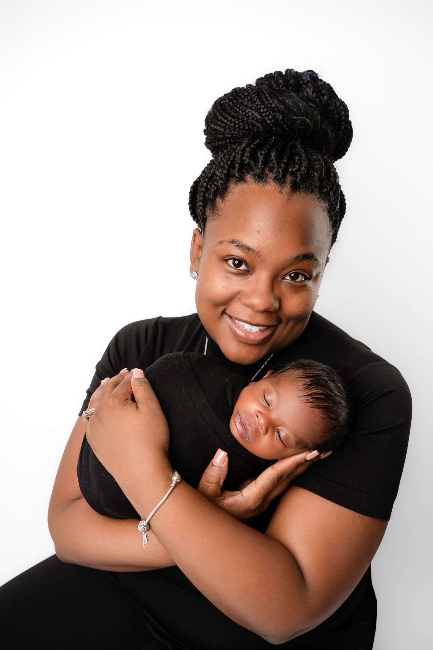 Metro Detroit newborn photographer capturing a peaceful newborn with mom portrait in studio