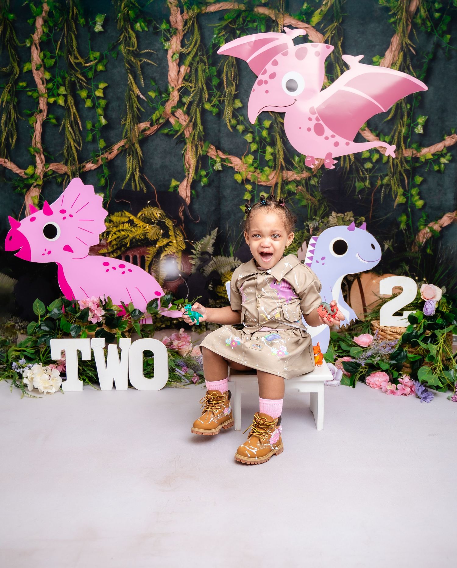 Metro Detroit children photographer photographing a toddler in studio Dinosaur themed birthday photo setup