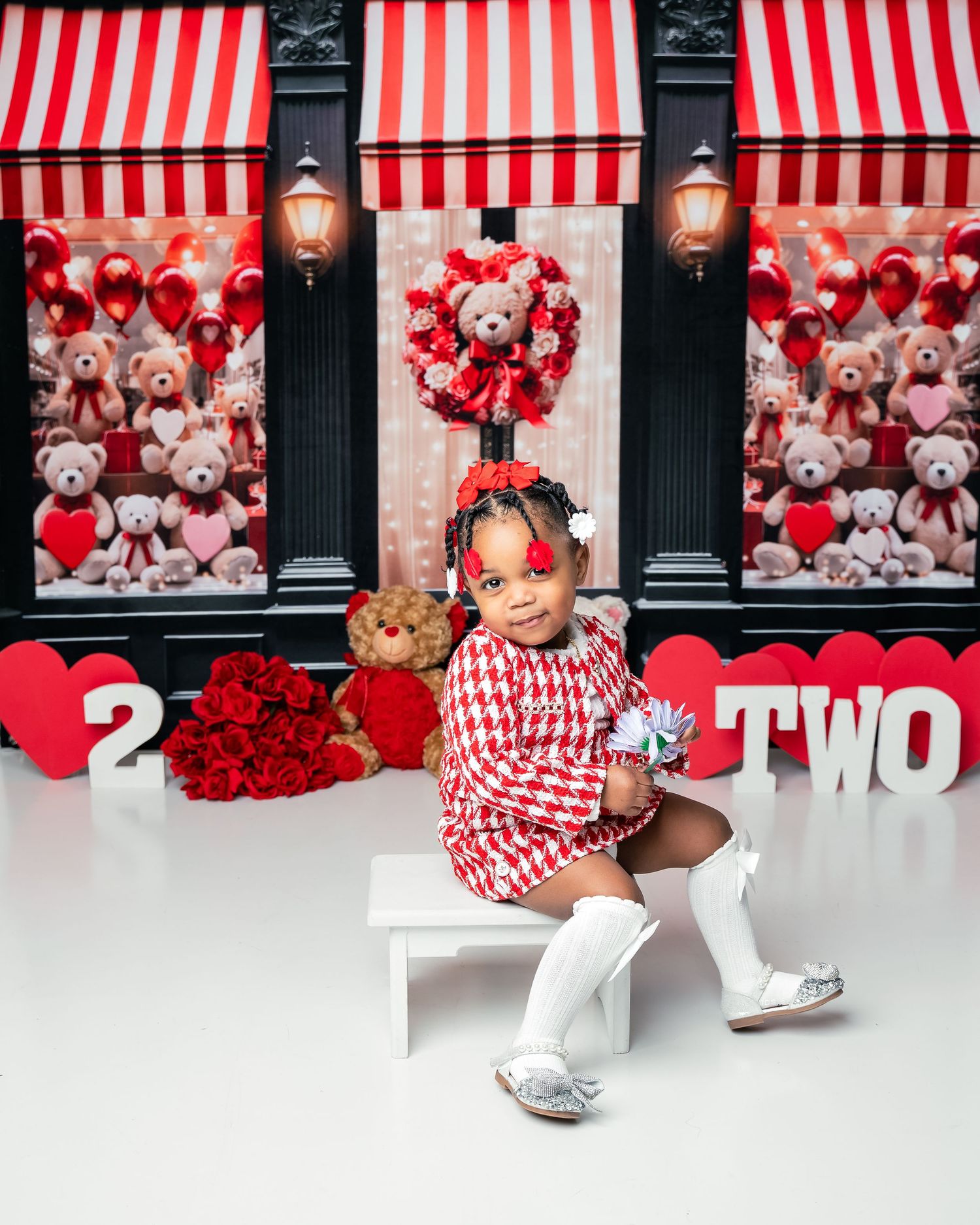 Metro Detroit children photographer Valentine's themed display with red and white striped awning, teddy bears, and heart decorations.