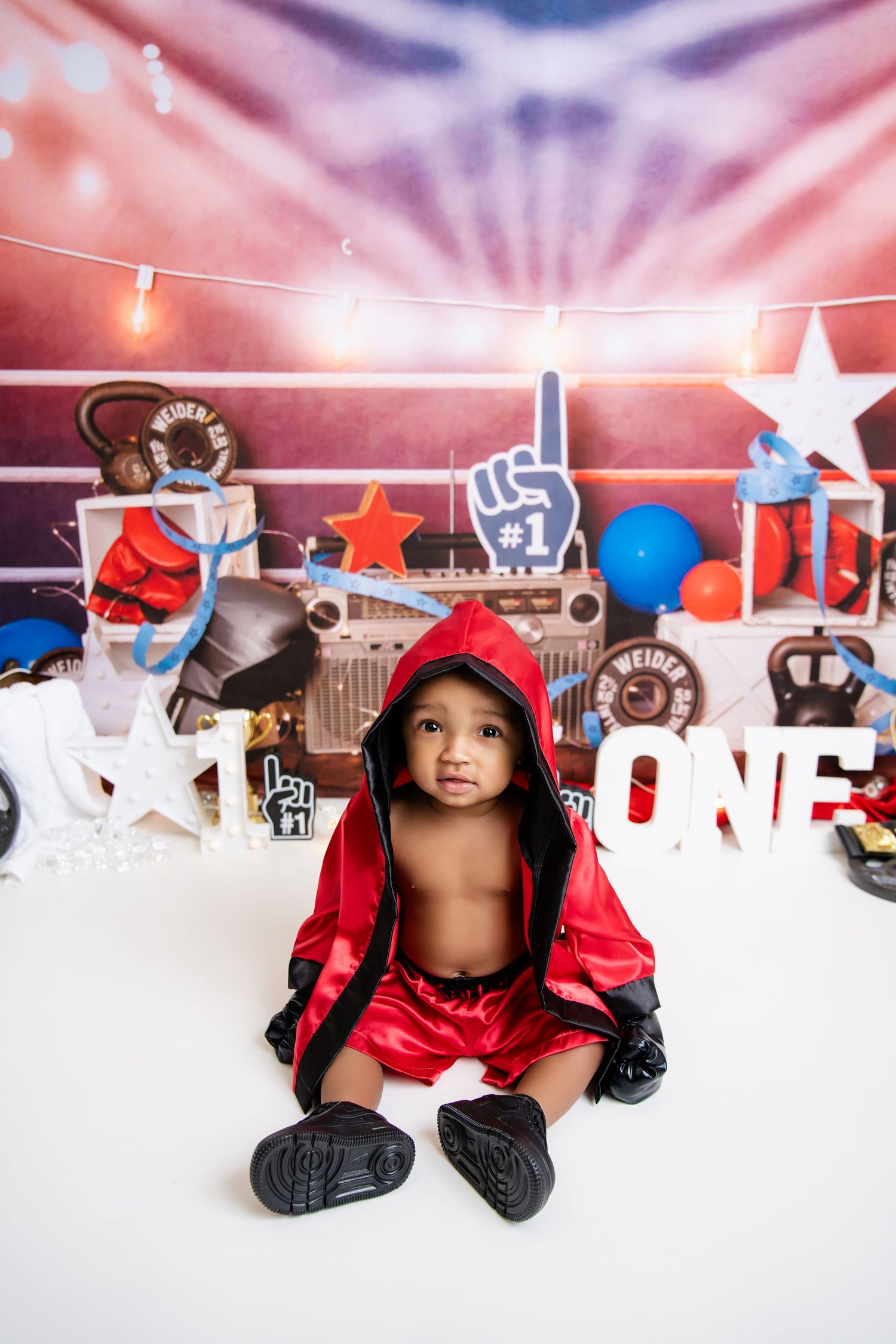 Metro Detroit children photographer photographing a playful toddler in studio Patriotic themed first birthday party setup