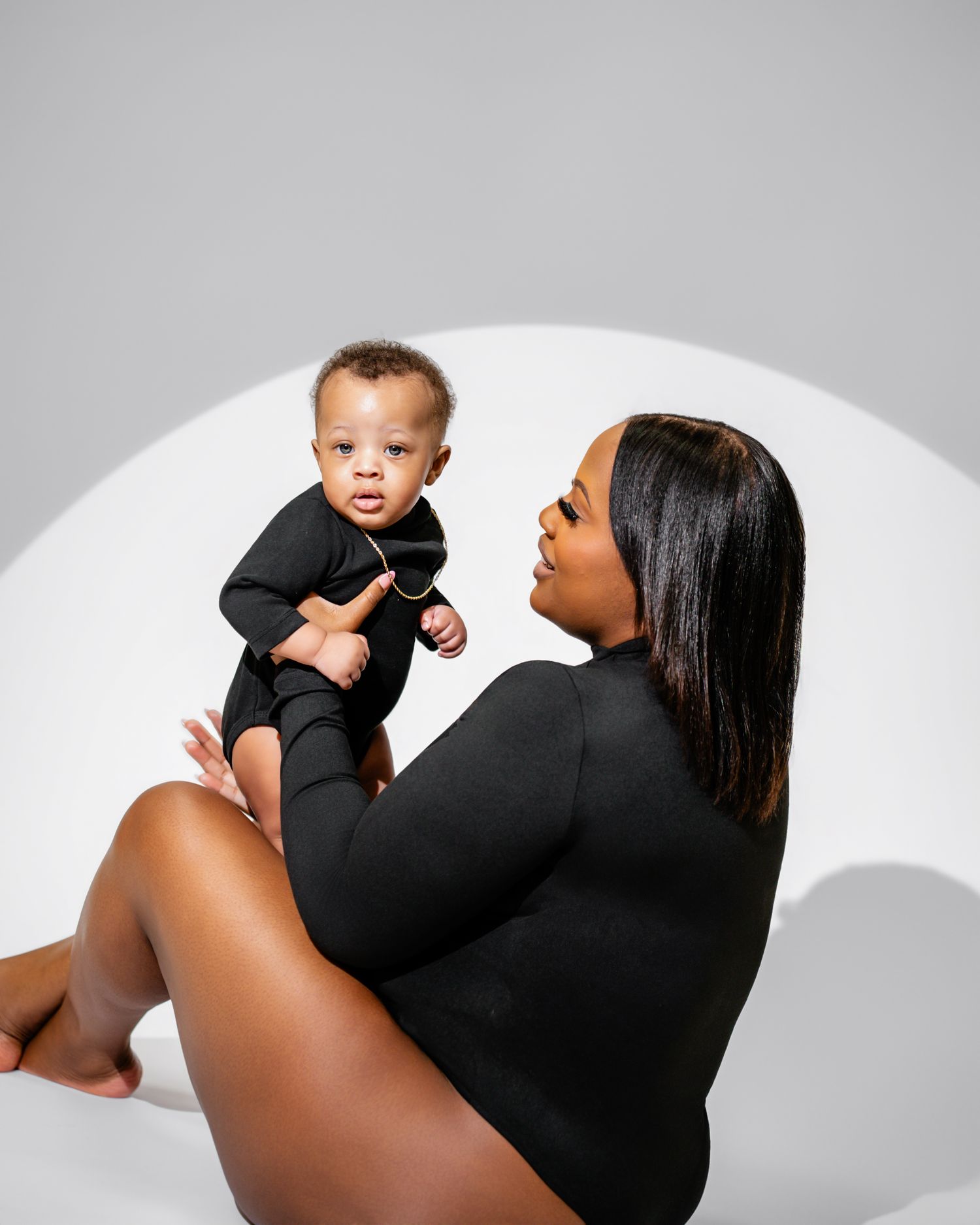 Metro Detroit family photographer capturing A tender moment captured in black and white as a mother and baby pose together