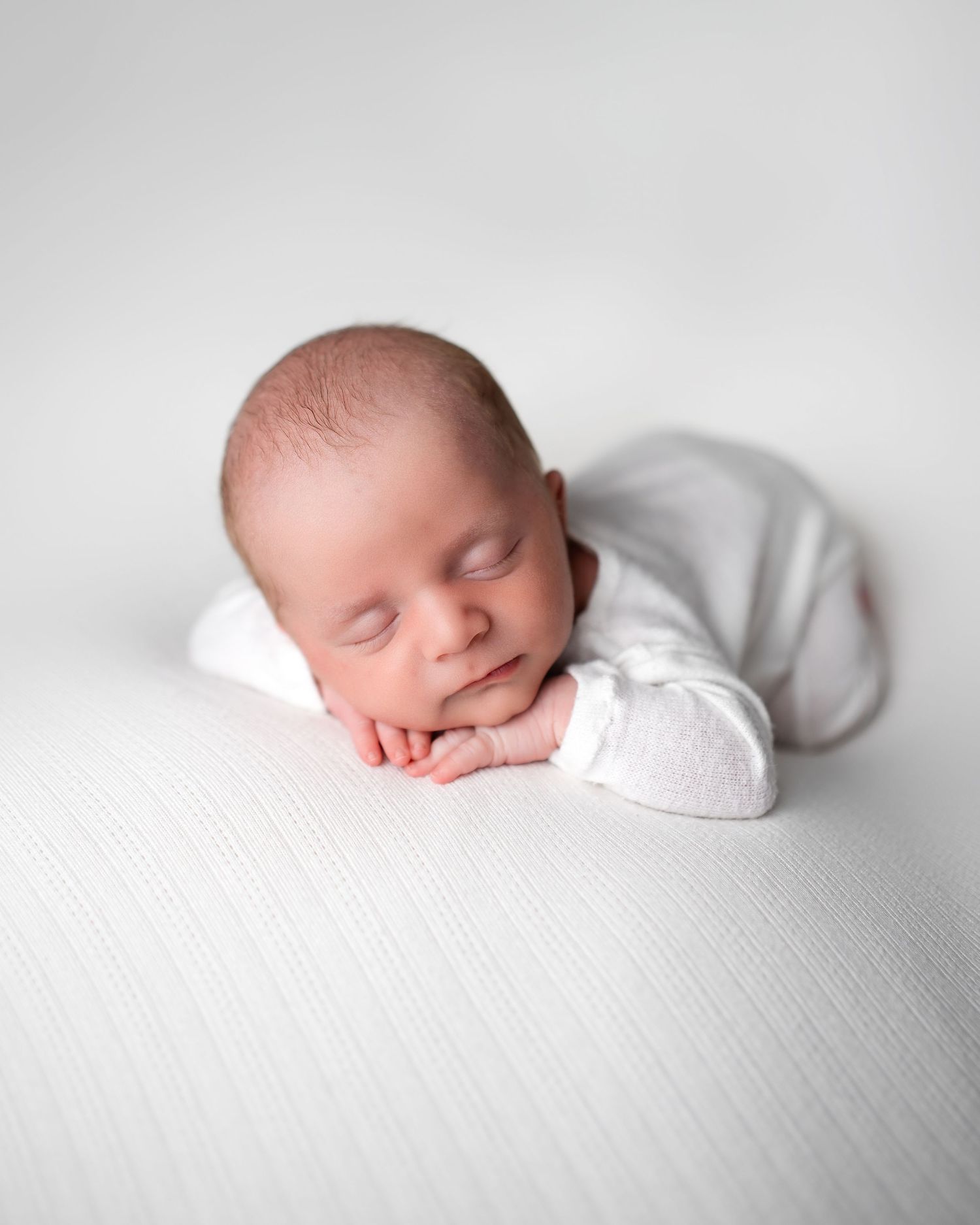 Metro Detroit newborn photographer capturing a peaceful newborn portrait in studio