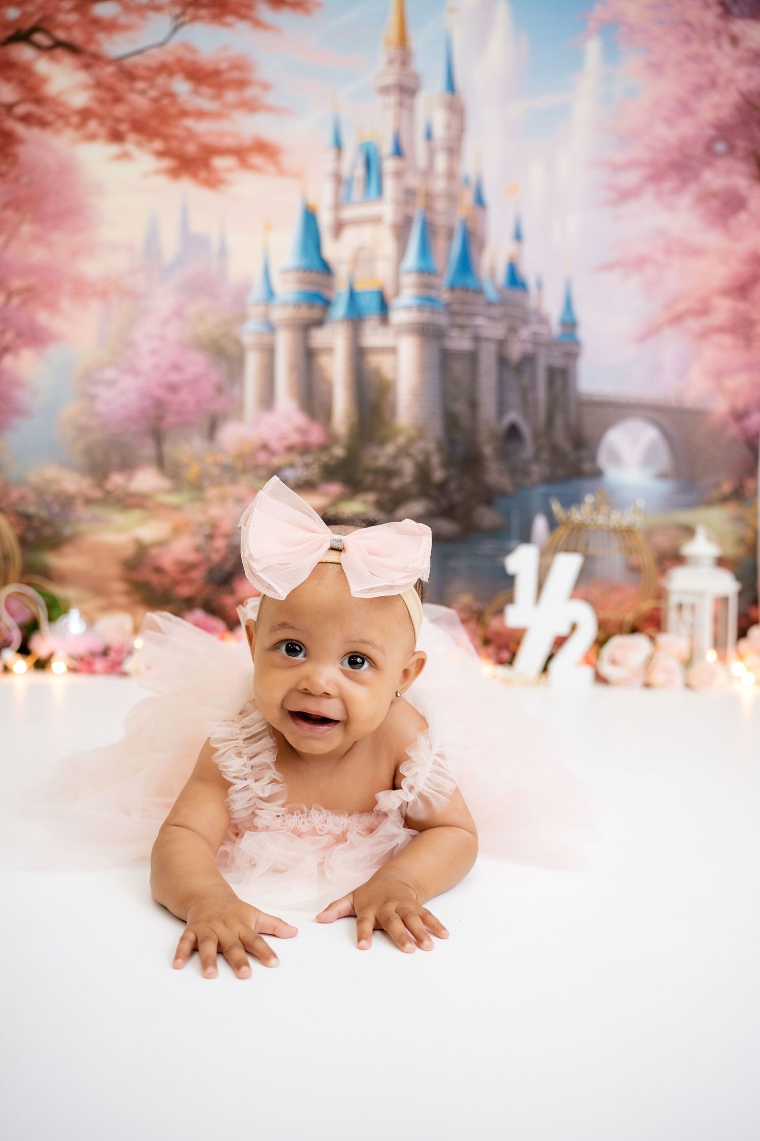 Metro Detroit children photographer Dreamy princess castle backdrop with pink cherry blossoms and magical lighting effects.