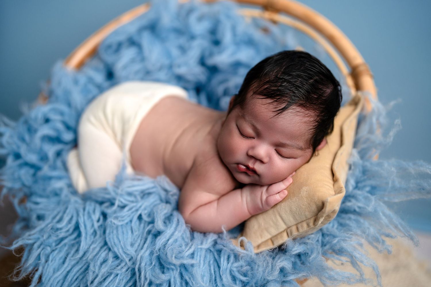 Metro Detroit newborn photographer capturing a peaceful newborn portrait in studio