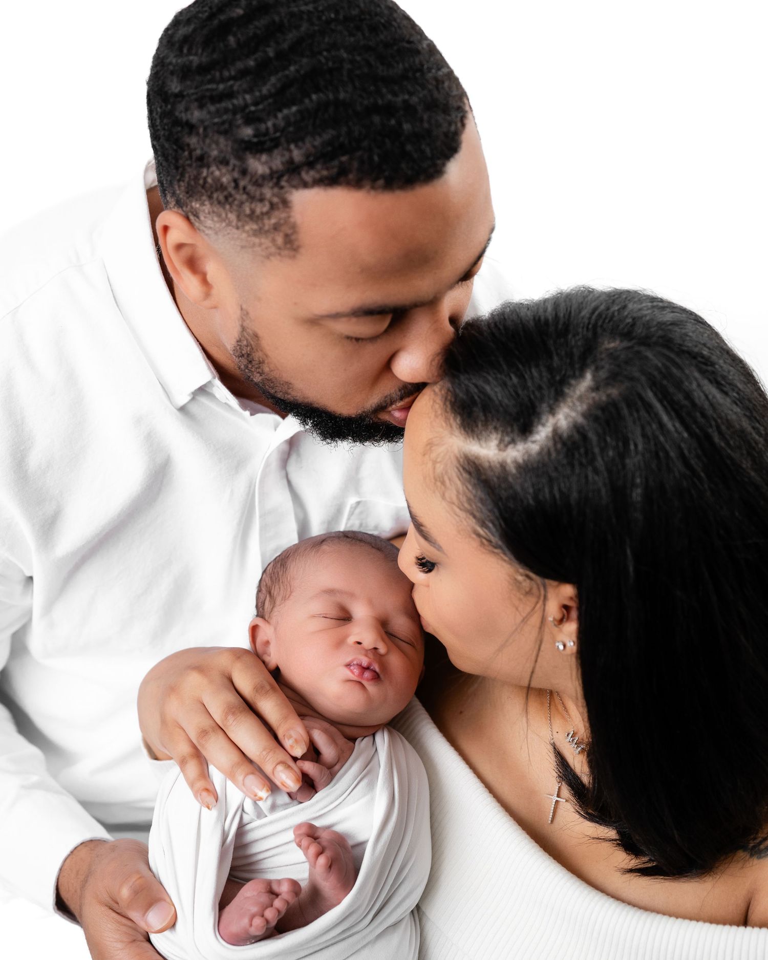 Metro Detroit newborn photographer capturing a peaceful newborn with parents portrait in studio