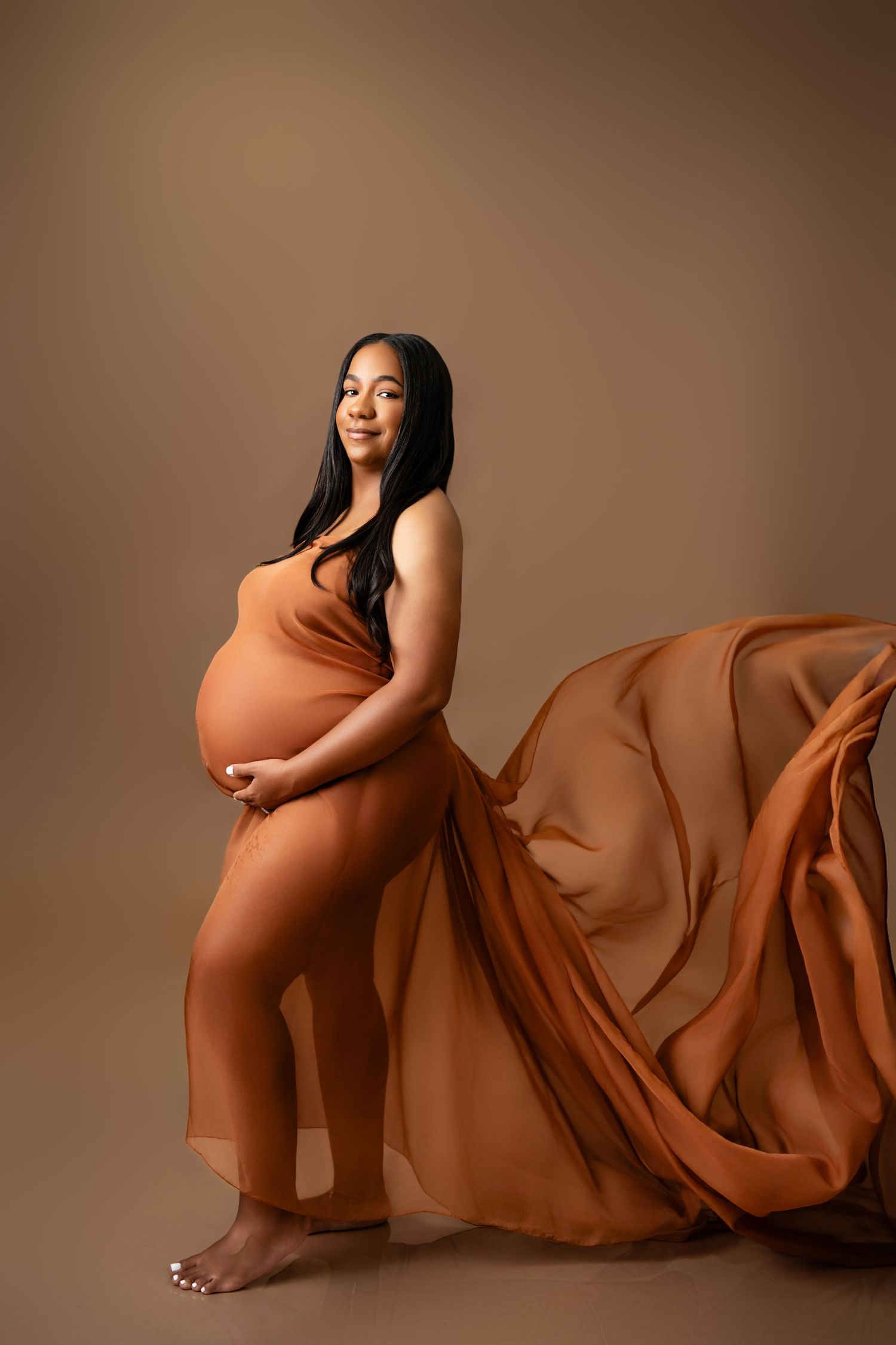 Metro Detroit maternity photographer capturing an expecting mother in studio