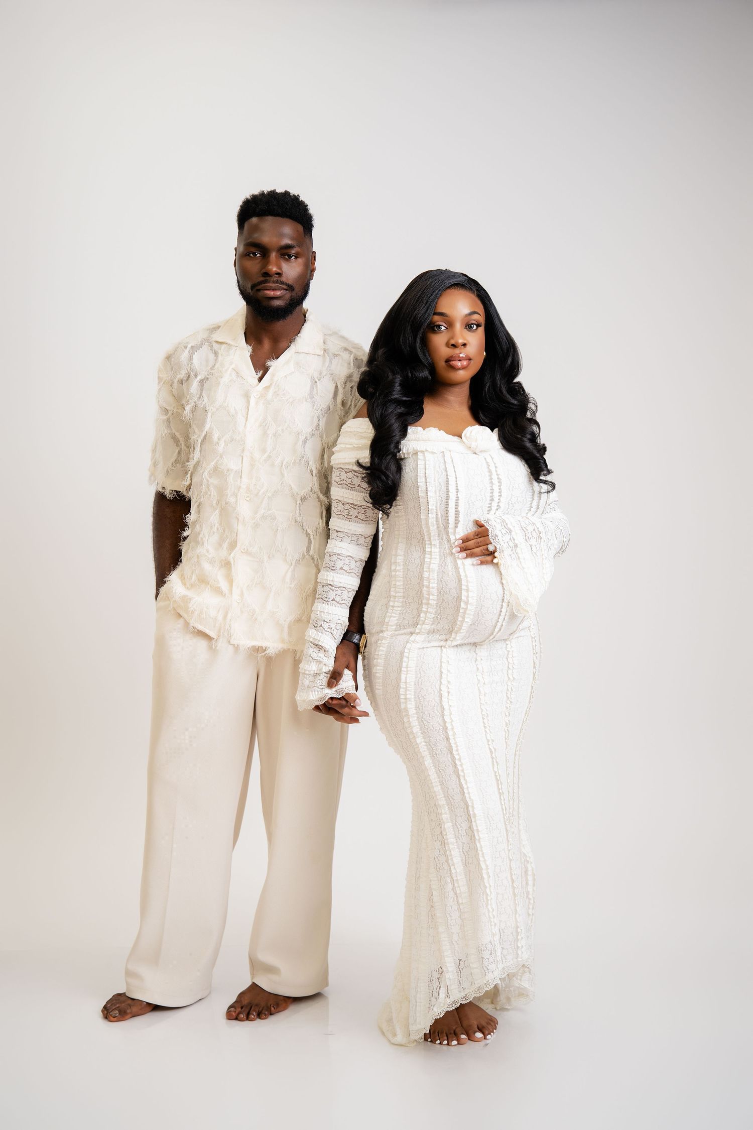 Metro Detroit maternity photographer capturing an expecting mother and husband in studio