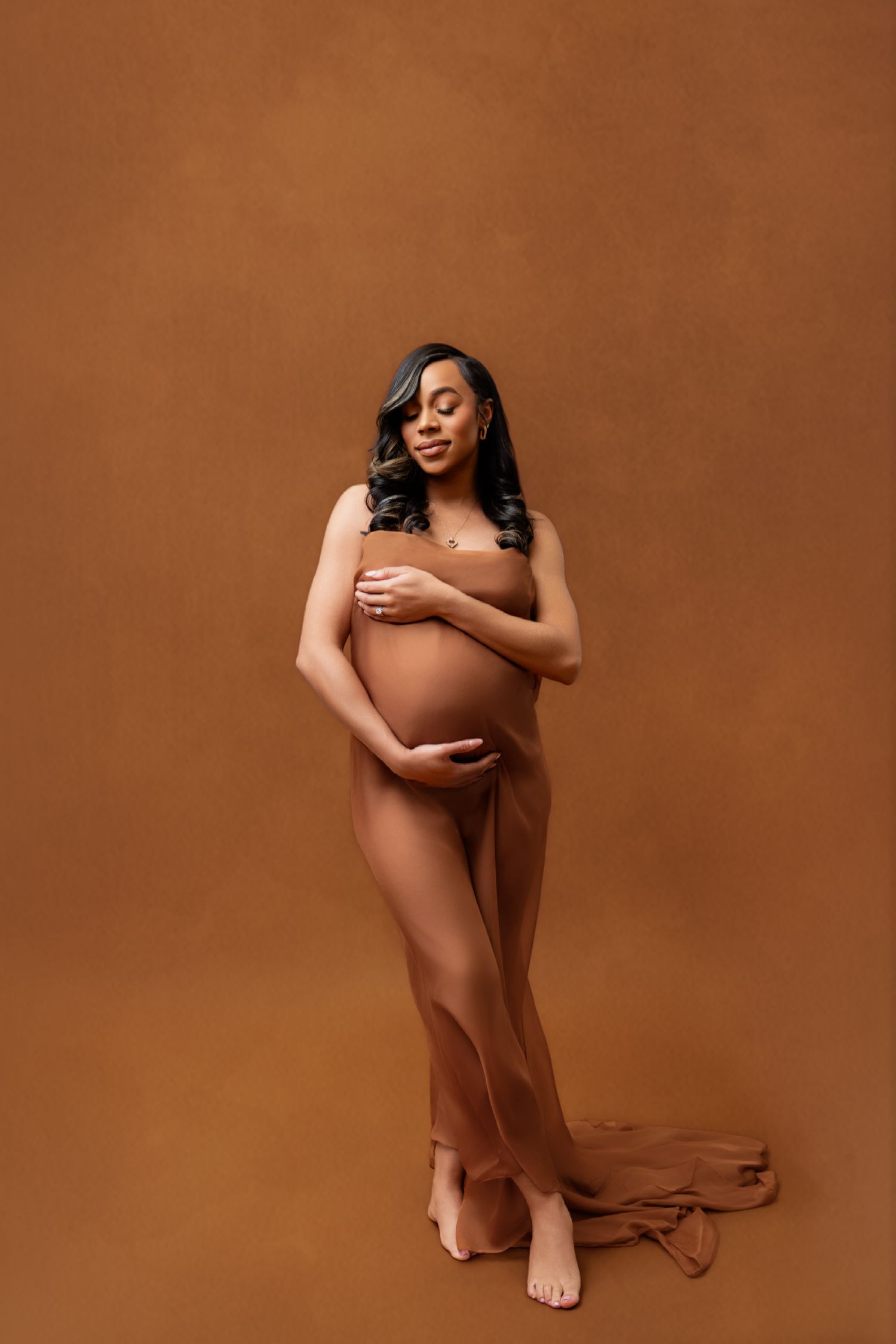 Metro Detroit maternity photographer capturing an expecting mother in studio