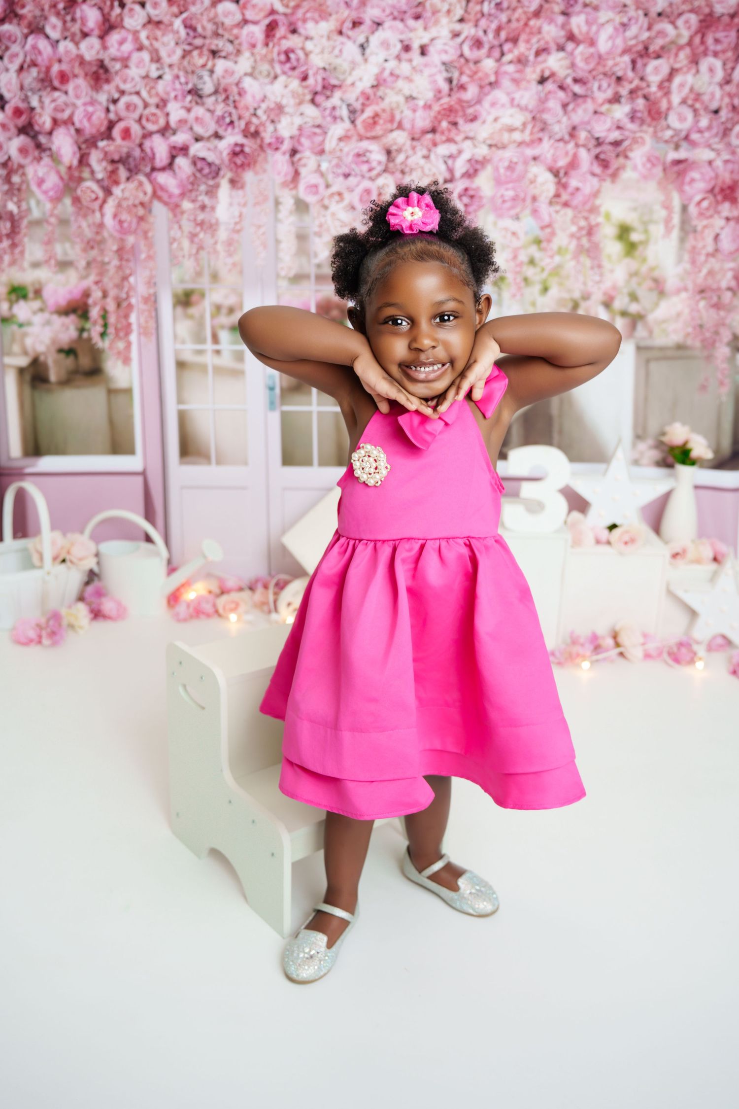 Metro Detroit children photographer photographing a playful toddler in a bright pink dress poses playfully