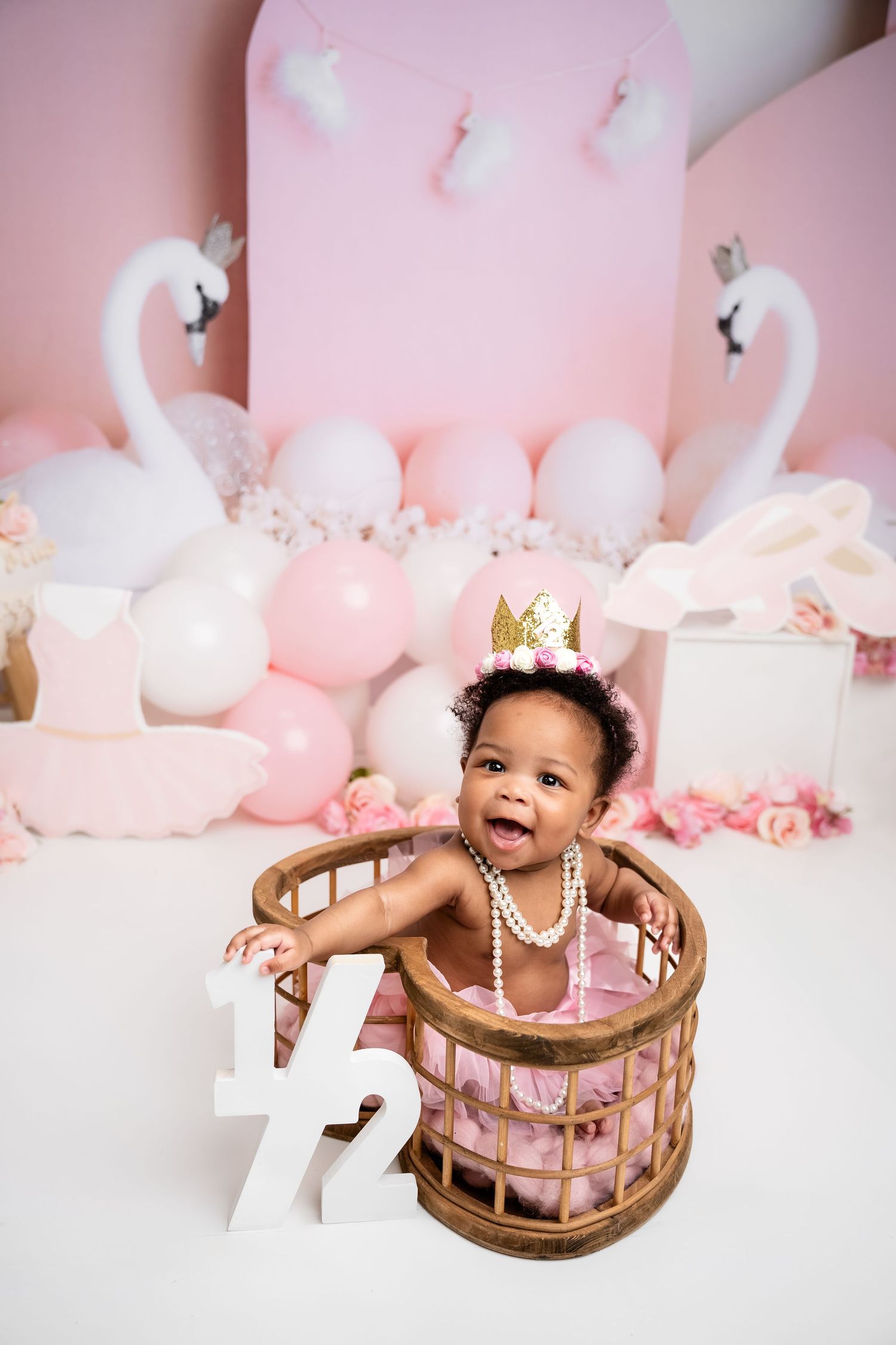 Metro Detroit children photographer Pink and white swan-themed photoshoot with decorative wooden basket.