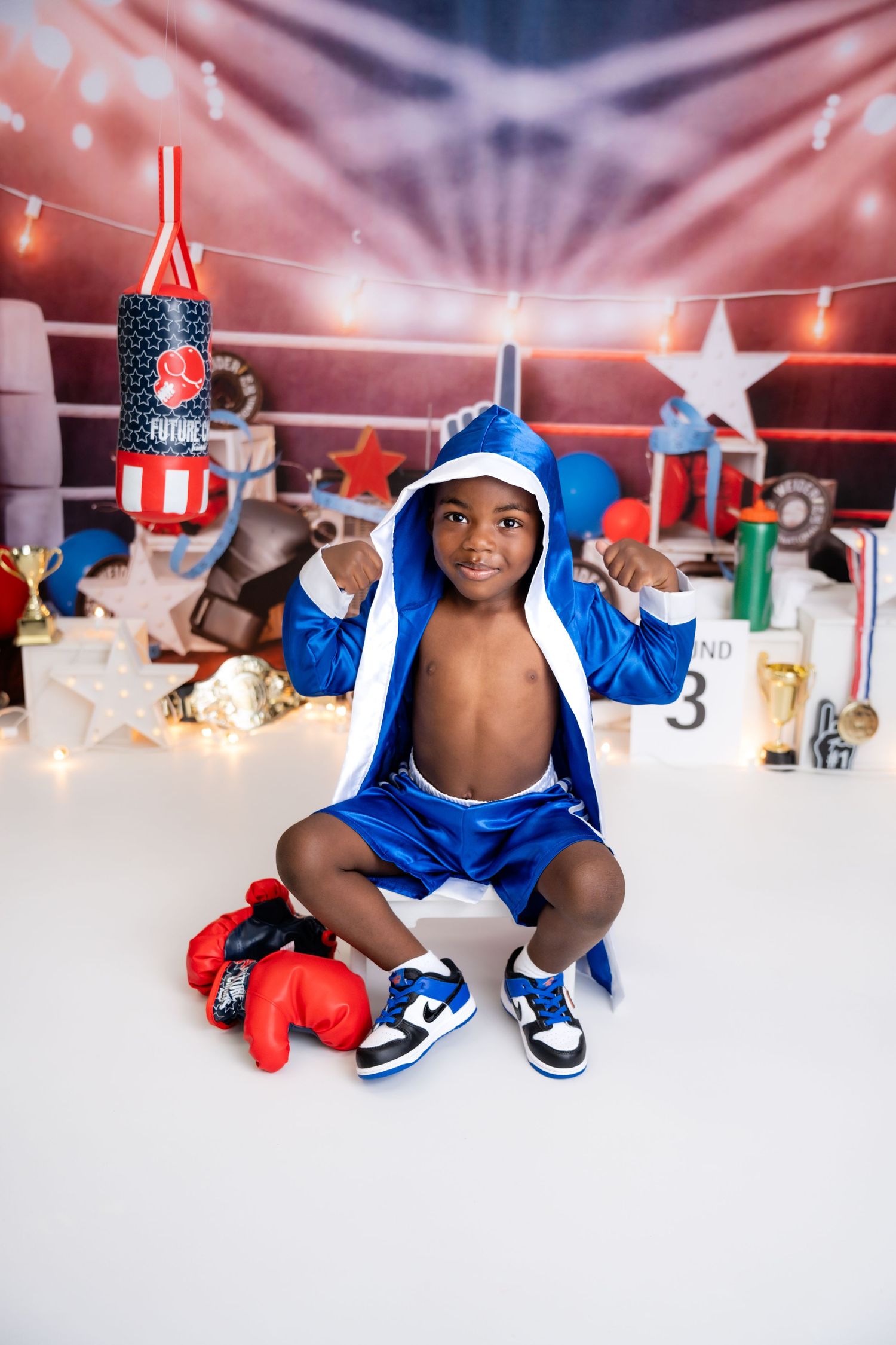 Metro Detroit children photographer Boxing themed photo setup with stars, lights and red boxing gloves.