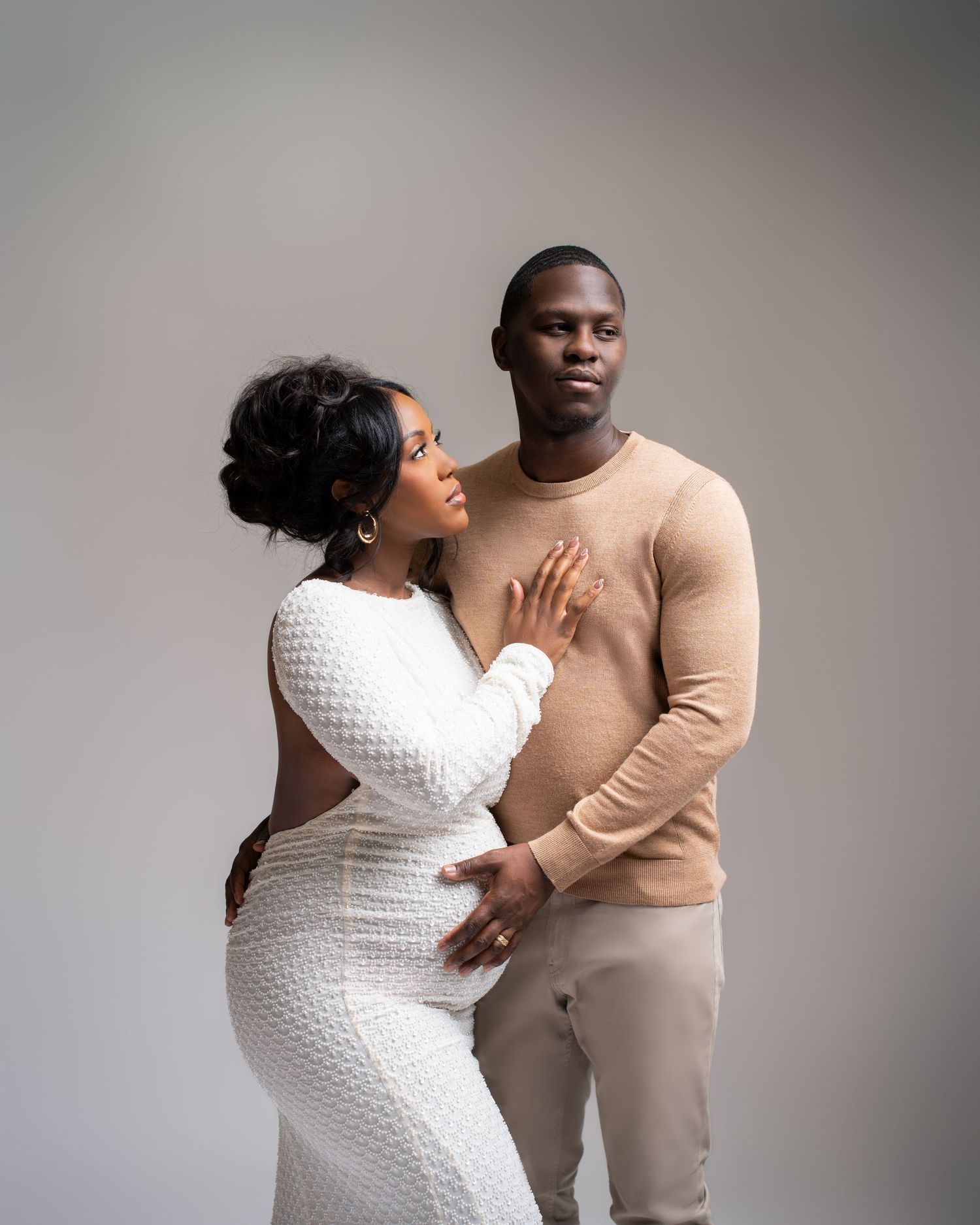 Metro Detroit maternity photographer capturing an expecting couple in studio